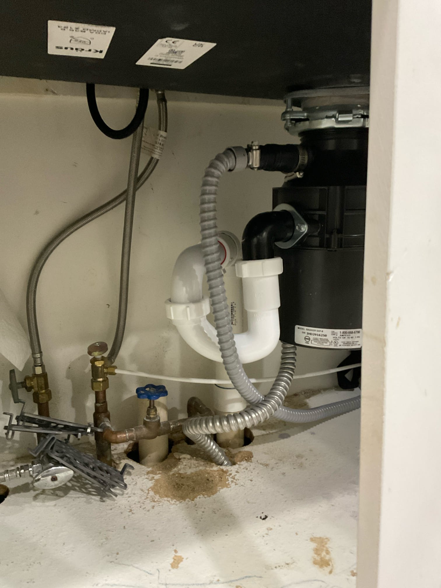 Under kitchen sink cut into drain line and add studer vent.

Customer stated that when water was draining through disposal, it will back up into icemaker line. Took a look under kitchen sink and found that kitchen drain line was trapped and recommended a customer to fix it in. Customer agreed. Went ahead and installed Studer vent and tested. Now kitchen sink is draining as it should and is not backing up into icemaker line. Cleaned up work area. Also took a look at the new water heaters that were installed and thermal expansion tank is undersized and also recommended to customer that piping water heaters in parallel instead of series is more efficient. Will send quote to do so.