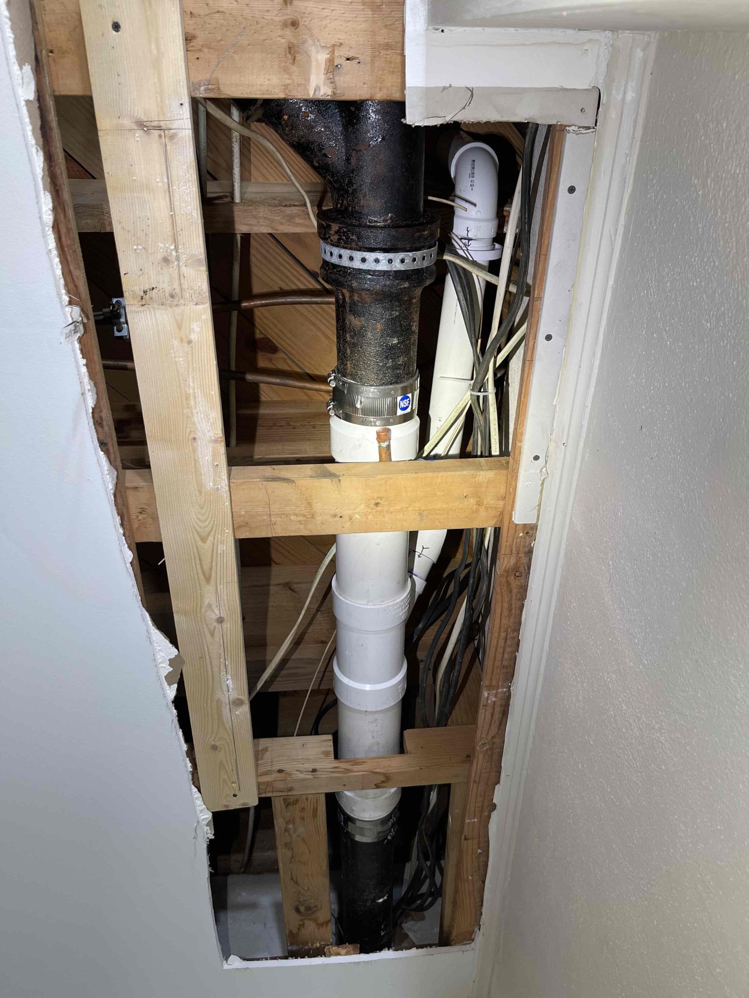 Came out for leaking kitchen drain. Arrived and found wet spot on drywall ceiling in the basement. Cut open the drywall and found a section of the cast iron has rotted out on the bottom side. Received approval to reroute the kitchen drain. Disconnected the cast iron in the basement and under the sink. Capped off the cast iron under the sink, in the basement, and the vent stack on the roof. Drilled down through cabinet. Cut out section of cast iron mainline and added new pvc branch line. Connected plumbing under sink down into new branch line in the basement. Installed AAV under kitchen sink. Tested to ensure proper function and a leak free installation. No further issue at this time. 