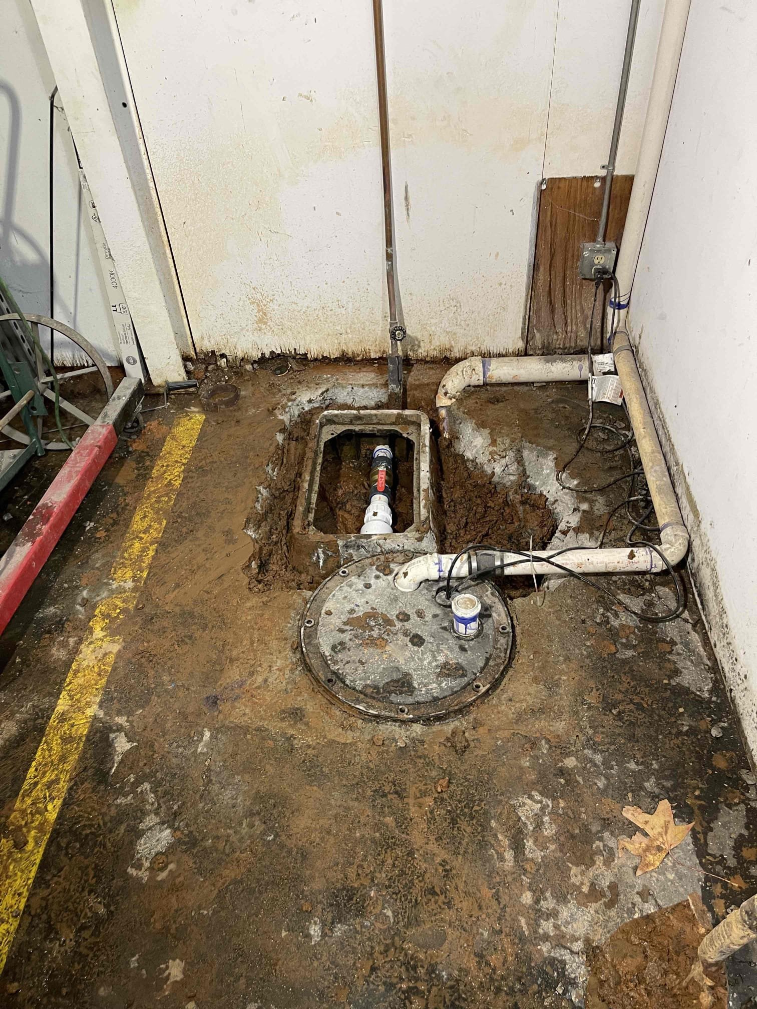 Came out for an issue with the sewage ejector that we previously replaced the float switch for back in may. This was not the problem today. 2” pvc make on the discharge side of the isolating ball valve had cracked. Pump was kicking on and spraying out of the broken fittings, flooding the box the backflow and valve were in, flowing back into the sewage pump basin and triggering the pump to kick on again and repeat the cycle over and over again. We notified managment of our findings and received approval to jackhammer up the box and repipe the outlet line. After removing the basin lid and pumping the sewage out of it, we found a massive root ball had grown into the basin and was surrounding the pump. When I was out here previously 7 months ago, there were no roots inside the basin. They grew through the gasket for the inlet pipe. We notified managment of our findings and received approval for additional work to jackhammer out more of the concrete and repair where the roots were getting i