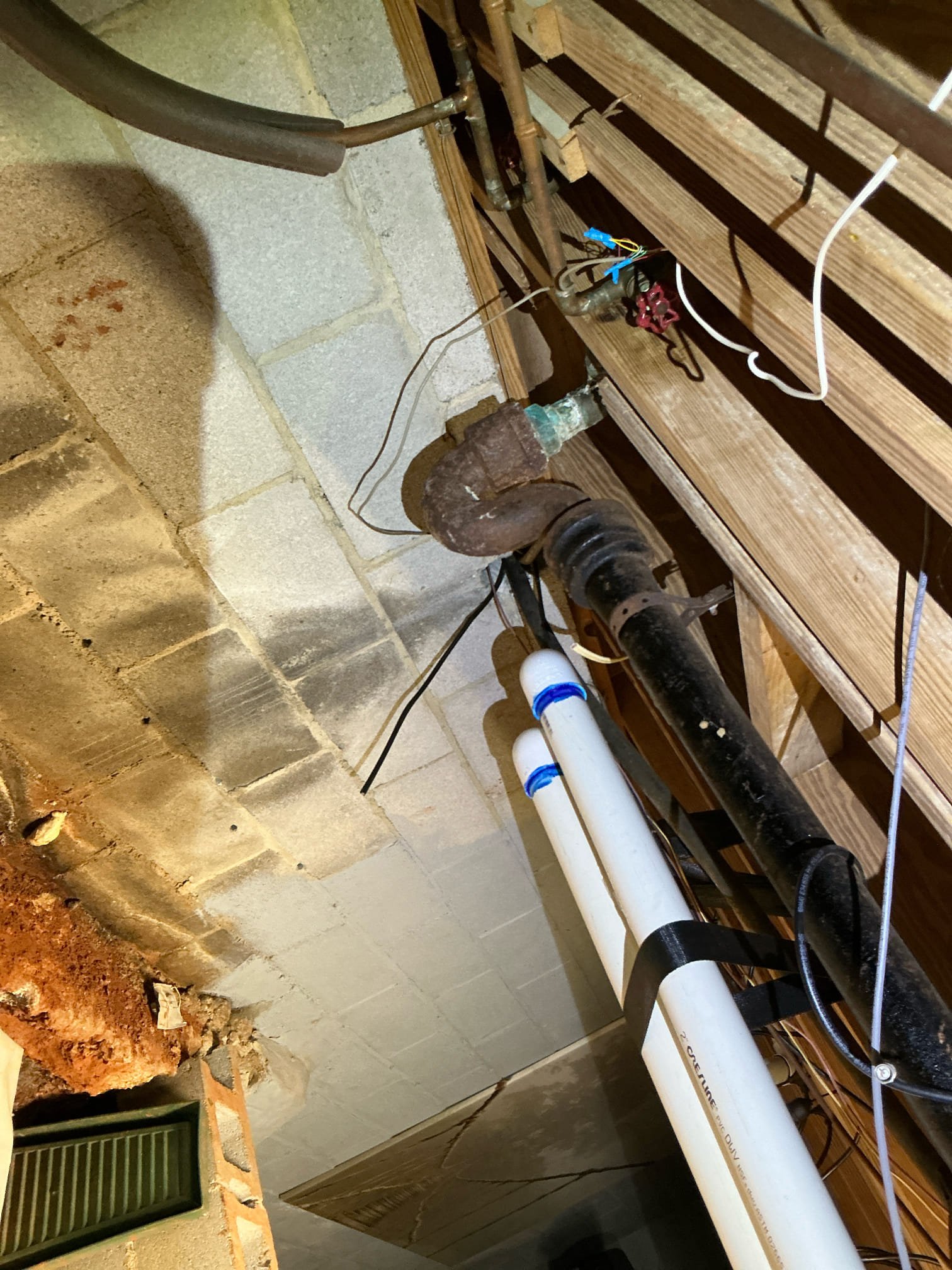 Client called us out today due to there being a leak that shows up on kitchen floor when kitchen fixtures were used. The waste arm in the wall was cast iron and copper and rest of home is still cast iron drains. Instead of pulling dishwasher and cutting the wall open, we left the old drain line abandoned in the wall, then drilled new 2” hole through bottom of cabinet and fed new 2” drain pipe through. Added new tee and studor vent up top, and below we cut out the few cast iron fittings right below the kitchen, and reconnected with new pvc properly supported and pitched. Once all connections were made, we tested our work with no issues. 

The old cast iron pipe was full of cast sludge, which will eventually start to cause issues in the home. Recommend jetting the line, and worst case replacing the line with pvc. 

1 yr warranty