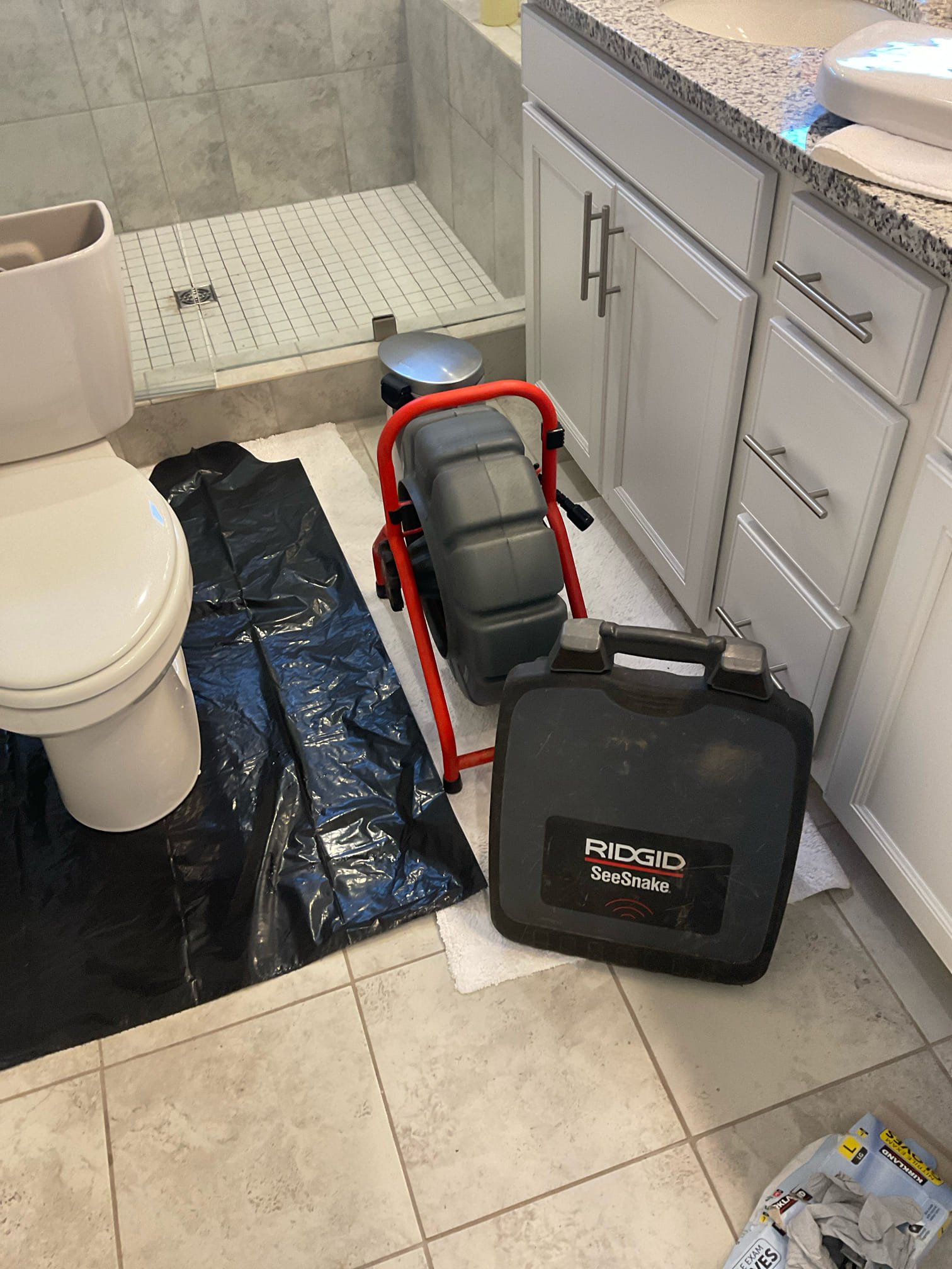 Pull and reset toilet in master bathroom, cleared blockage and camera inspection found a area with slightly back pitched pipe 