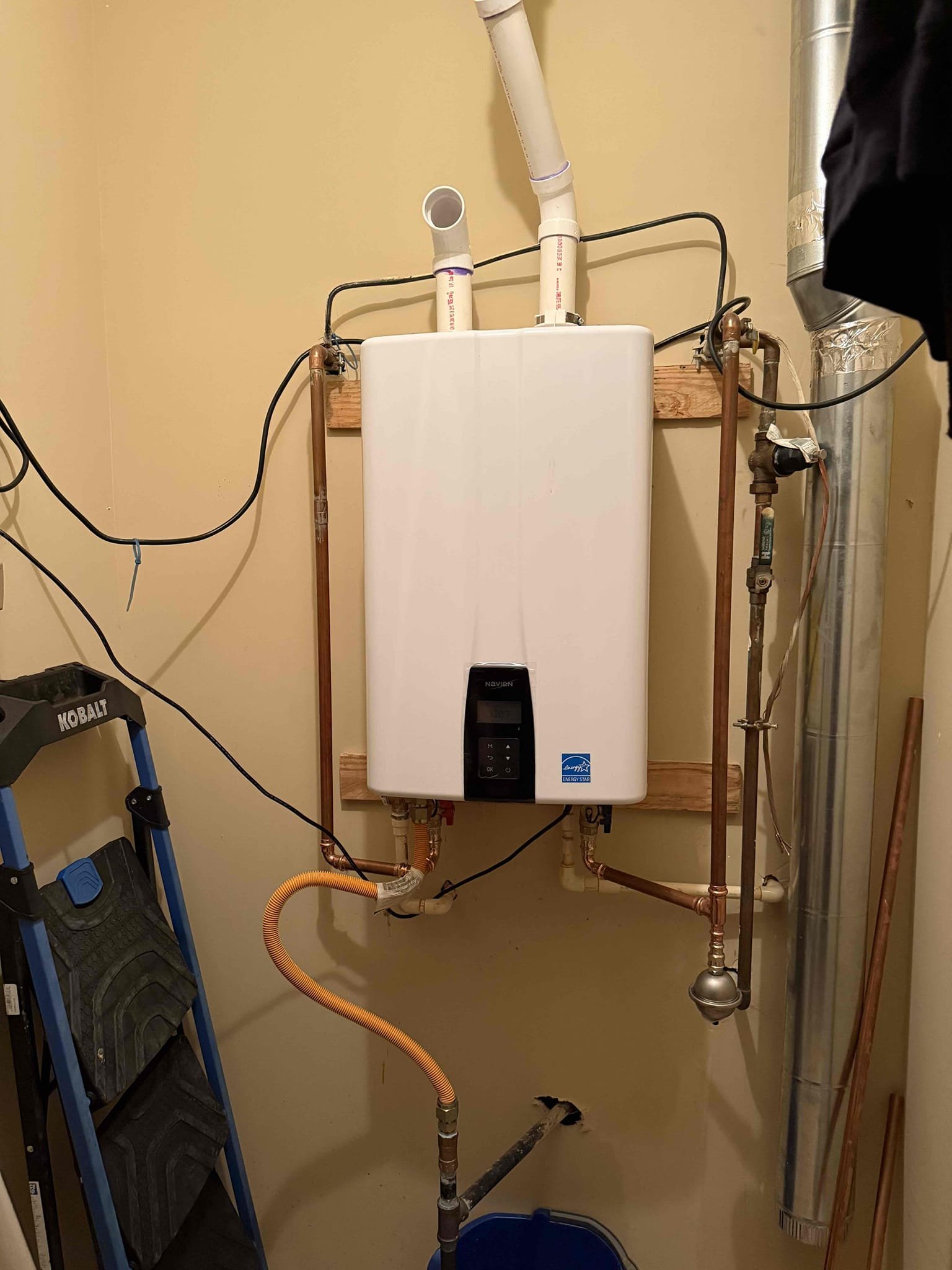 Returned to install new navien 240a2 tankless. Installed new navien tankless, new service ports, new expansion tank and reworked vent out of the roof. Turned on gas and water to tankless. Confirmed tankless is working properly and not throwing error codes. Tankless is working properly, and no leaks upon departure 