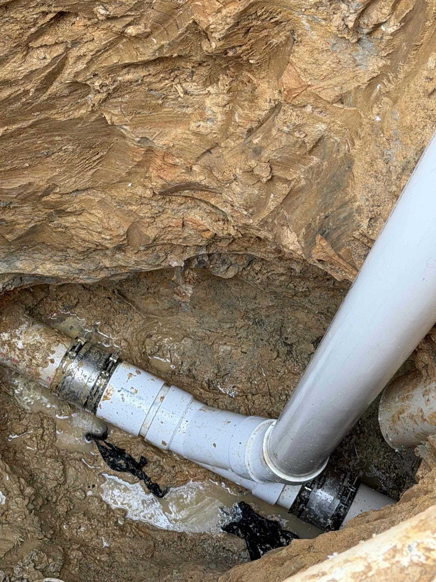 Excavate approximately 10 feet down from cleanout, replace section of pipe that is broken and then after excavation has been complete we will jet line to ensure rest of the line is clear as well as scope line to ensure line is in good working order as well as add a two way  cleanout to facilitate maintenance 




  17-19


 mainline repair and replacement.

 we were called out to address a broken cleanout located approximately 10 feet deep during excavation. We discovered an additional issue with the mainline exiting the house. We presented the customer with repair options and they chose to proceed with both the cleanout replacement and the main line repair 

work performed 

excavated to access and replaced the broken cleanout. Repaired the identified issue on the mainline, exiting the house and thoroughly tested the line after repairs we compacted the soil and concrete under the repair site to help prevent future settling noted that the ground was saturated and while we have taken ev