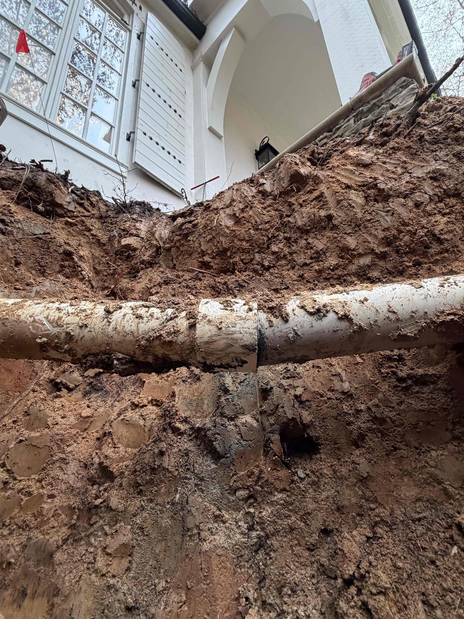 Excavate approximately 10 feet down from cleanout, replace section of pipe that is broken and then after excavation has been complete we will jet line to ensure rest of the line is clear as well as scope line to ensure line is in good working order as well as add a two way  cleanout to facilitate maintenance 




  17-19


 mainline repair and replacement.

 we were called out to address a broken cleanout located approximately 10 feet deep during excavation. We discovered an additional issue with the mainline exiting the house. We presented the customer with repair options and they chose to proceed with both the cleanout replacement and the main line repair 

work performed 

excavated to access and replaced the broken cleanout. Repaired the identified issue on the mainline, exiting the house and thoroughly tested the line after repairs we compacted the soil and concrete under the repair site to help prevent future settling noted that the ground was saturated and while we have taken ev