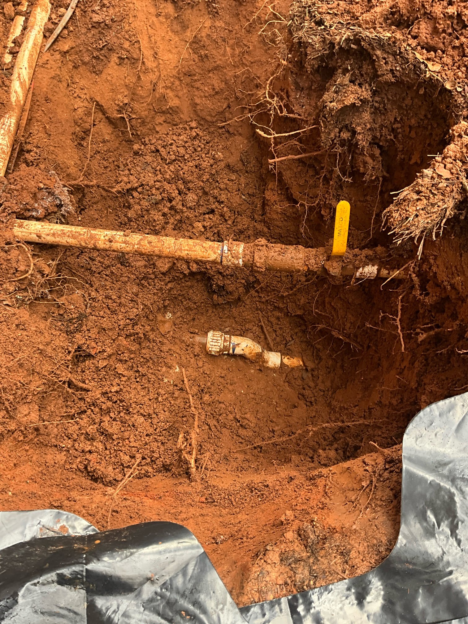 Call for water main leak.

Arrived and met with Ms. Karen and William. Karen noticed loud noise, and subsequently water pooling in basement. Upon investigating they found water pooling inside a shut off valve box for the irrigation. Water service provider states that water use spiked on the 23rd of this month.

I dug down and found a break on an offset for 1 inch pvc line. PVC was installed in the middle of copper for the later addition of an irrigation system. Irrigation is no longer used due to an unlocated leak. Concrete was poured and in the way of the waterline, and pvc was flexed. Break was consistent with  pressure from tension on line. I removed the pvc together and replaced with type L 1 inch copper. Irrigation discontinued at the request of Ms. Karen. Line is located approximately 3 feet deep, directly below hose spigot.

Tested pressure and found that the pressure is slightly over 82psi at ~2pm on a Saturday. Prv is approximately 27 years old. Also discussed concerns with ho