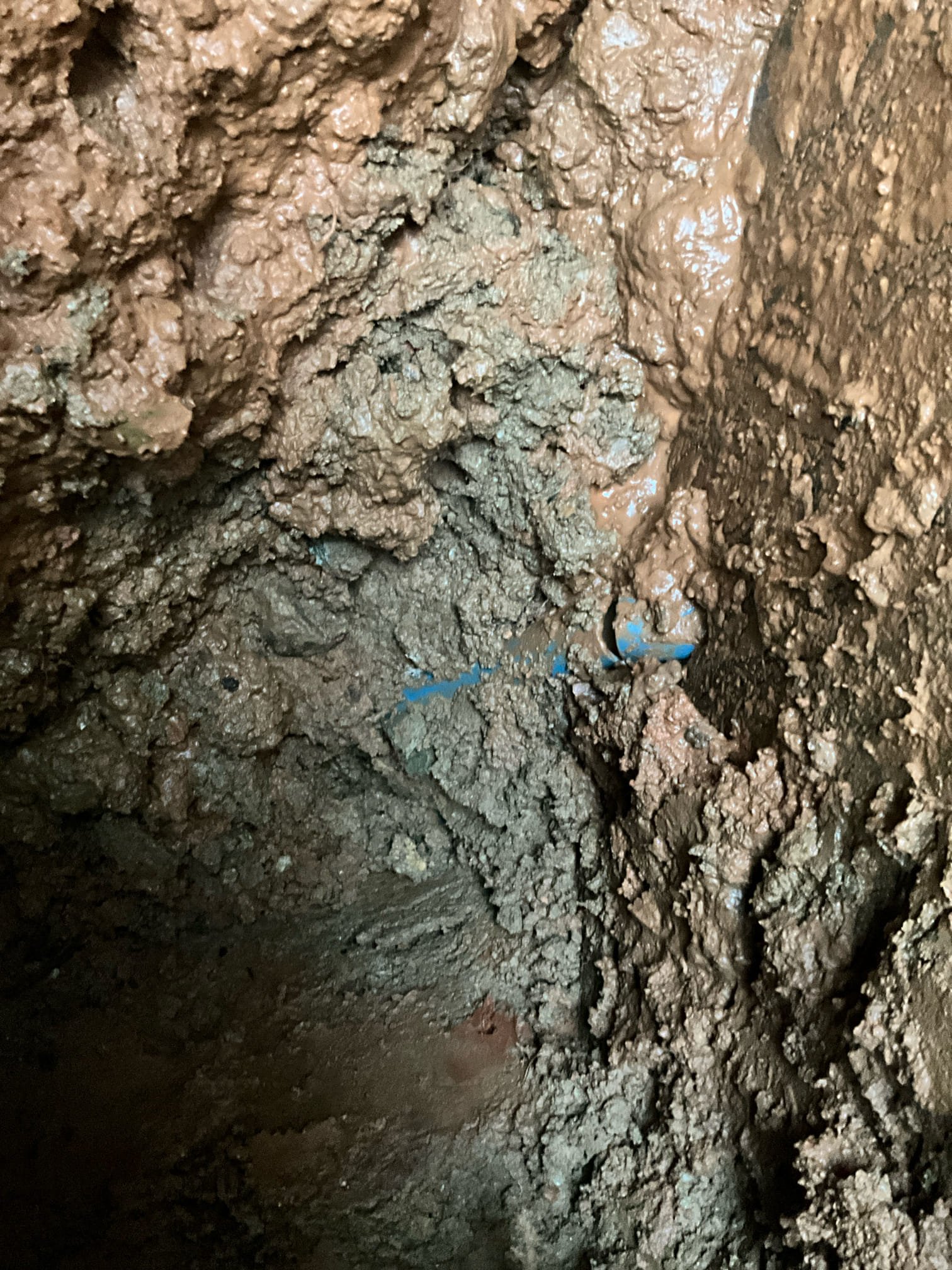 Call for water main leak near house.

Arrived and spoke with Mr. Keith. We were out several days ago to repair a break on the irrigation line. Today there is a leak from near the house. 

I dug down approximately 4-5 feet and found a nearly totally severed blue poly line. Main line is 1 inch blue poly, which is a known defective pipe material. However, I believe this rupture has occurred due to the entry angle and tension on the main line. I cut out bad section, drilled new hole in foundation at correct angle. New waterline was sleeved and water proof concrete applied to new penetration and old waterline penetration. New main shut off installed and lowered to be more accessible. Pressure regulating valve was nearly 30 years old. Although pressure read fine during last visit, I believe this was. False read due to ruptured waterline. We replaced prv to protect home from further issues. 

When backfilling hole, I mentioned that much of the clay has been washed away, and Mr. Keith states t