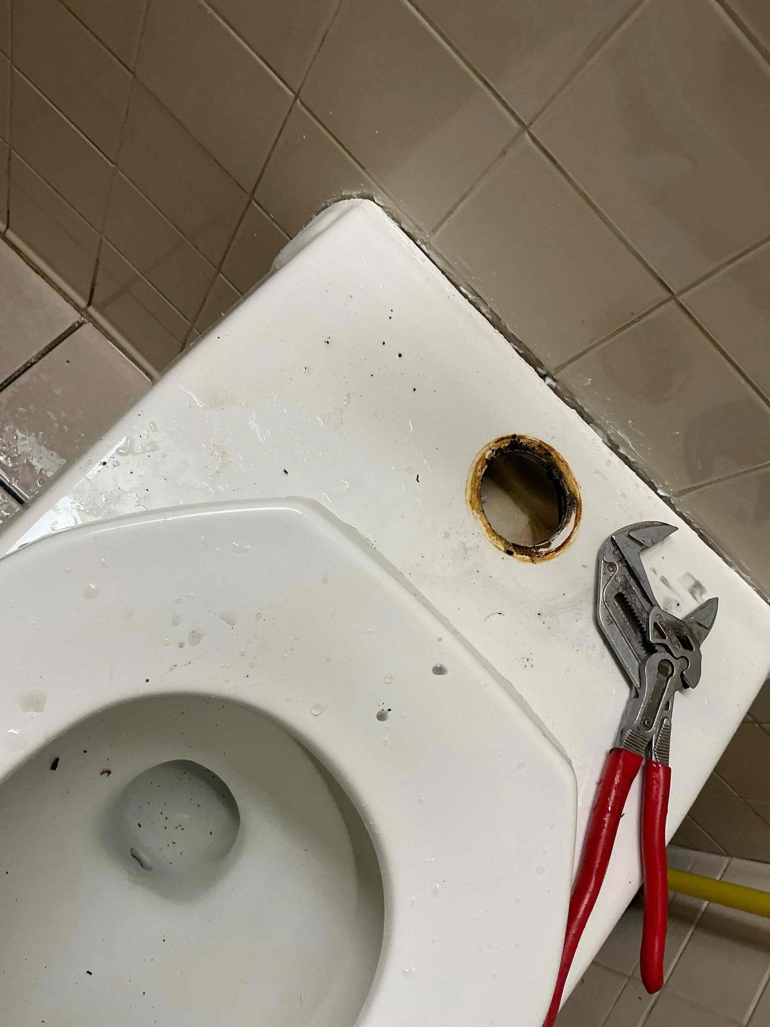 Called out today due to the men’s bathroom upstairs in the office leaking from the back onto the floor. It was leaking from the flange, which had a wax ring on it, as well as a rubber gasket which is not supposed to be used together. Removed the old wax and gasket and installed new wax ring with horn and re hung the wall hung toilet and fastened the 4 bolts. While putting back together, noticed a small drip at the toilet spud. Tightened it up just a bit, and it got worse. Removed and saw the rubber sealing gasket for it was completely gone which is why is did what it did. Replaced that toilet spud after rehanging and tested. No more leaks.

Advised client to not use that toilet for at least 48 hours.