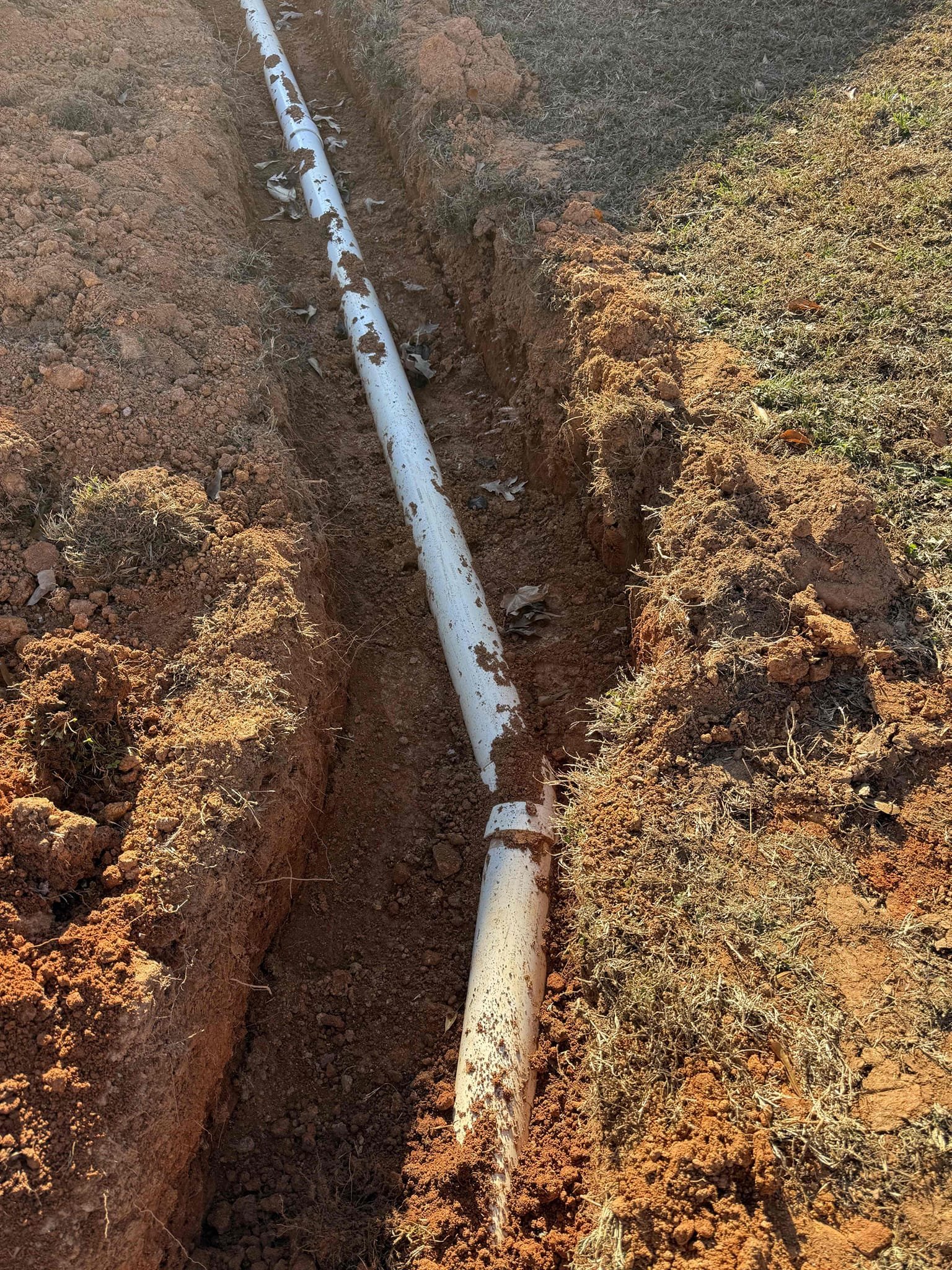 Partial Sewer Main Outdoor Installation - Less than 65 feet in developed length AND less than 8 feet at deepest point: Installation of an exterior sewer line up to 70 feet in developed length, with trench depth not exceeding 8 feet. Scope includes excavation, pipe installation with proper slope, suitable bedding, backfilling, and connection to the existing sewer or municipal system. Cleanouts are included as needed for access. Work is performed with a focus on proper function, structural integrity, and long-term performance of the system.

Warranty: Includes a 5-year parts and labor warranty covering the complete sewer main installation.

Warranty Disclaimer: Warranty excludes damage or blockages caused by improper use, including flushing “flushable” wipes, feminine products, paper towels, grease, or other foreign objects, as well as excessive use of chemical drain cleaners. Proper use and maintenance are required to keep warranty coverage valid. We are also not responsible for the res