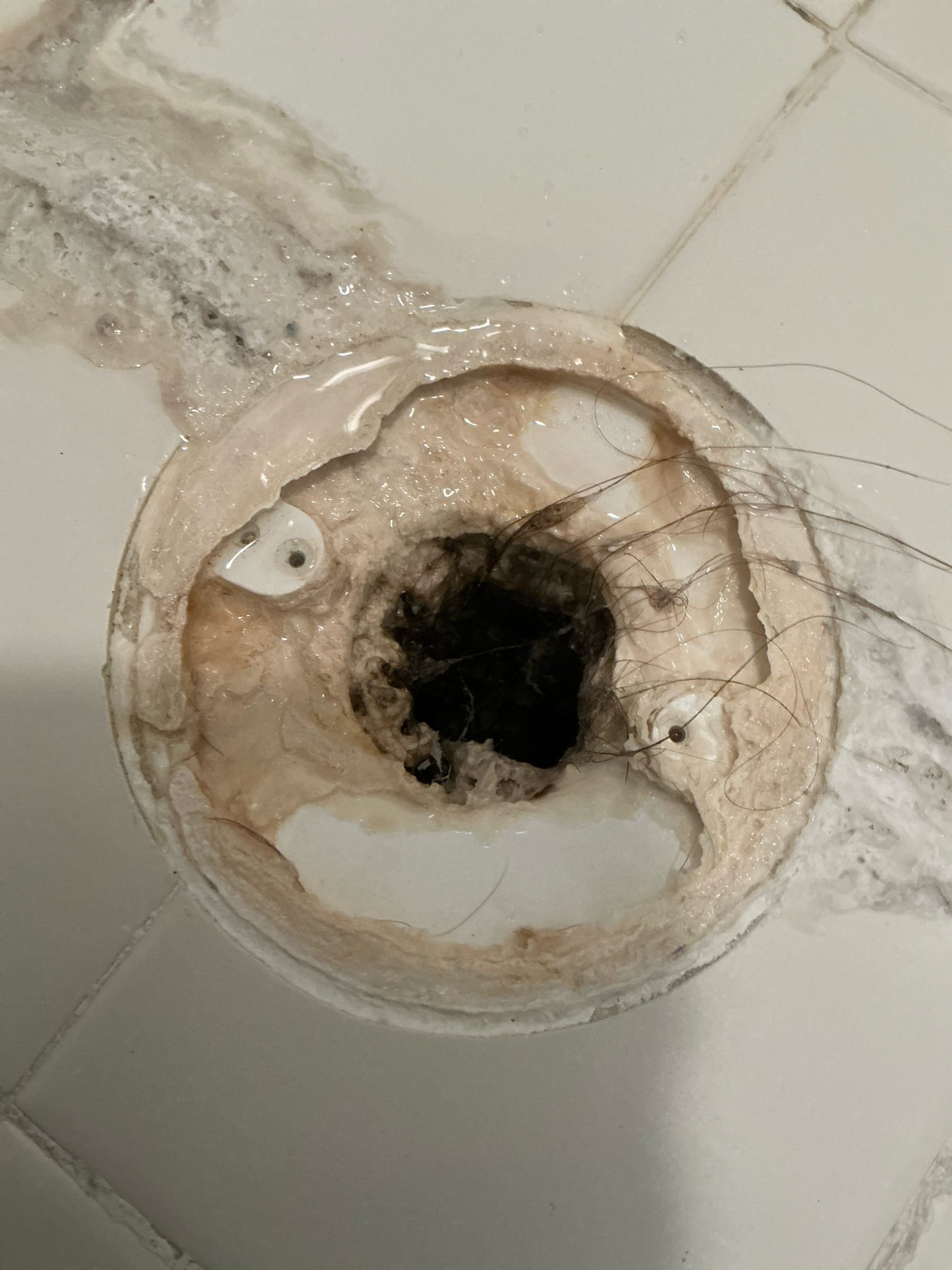 Client called us out today due to the master bathroom shower stall not draining as it should, and the master bath toilet seemed to be a little slow flushing. Upon further observations, we saw the toilet is still currently flushing, though it may be slower than usual. Over time, toilets can lose their flush power from calcium buildup inside the toilet, causing some slower flushing. Only recommendation for that toilet is to have us replace it with a new toilet customer provides. 
In the shower stall, there was a good bit of buildup, soap scum, and calcification and hair in the drain. Ran small chain snake down the shower drain and cleared it all out, rinsing it out between passes. Once cleaned, reinstalled the drain cover. All should be good to go. 