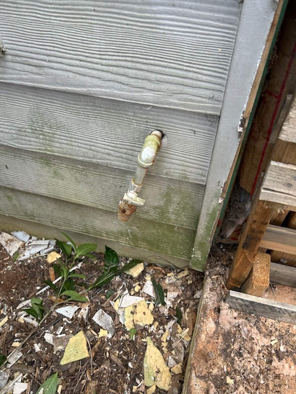 Cut out piping to the fireplace. Capped off the stub out coming out of the exterior wall. Bubble tested to ensure no leaks on accessible piping. Painted pipe to match exterior and prevent rust. 