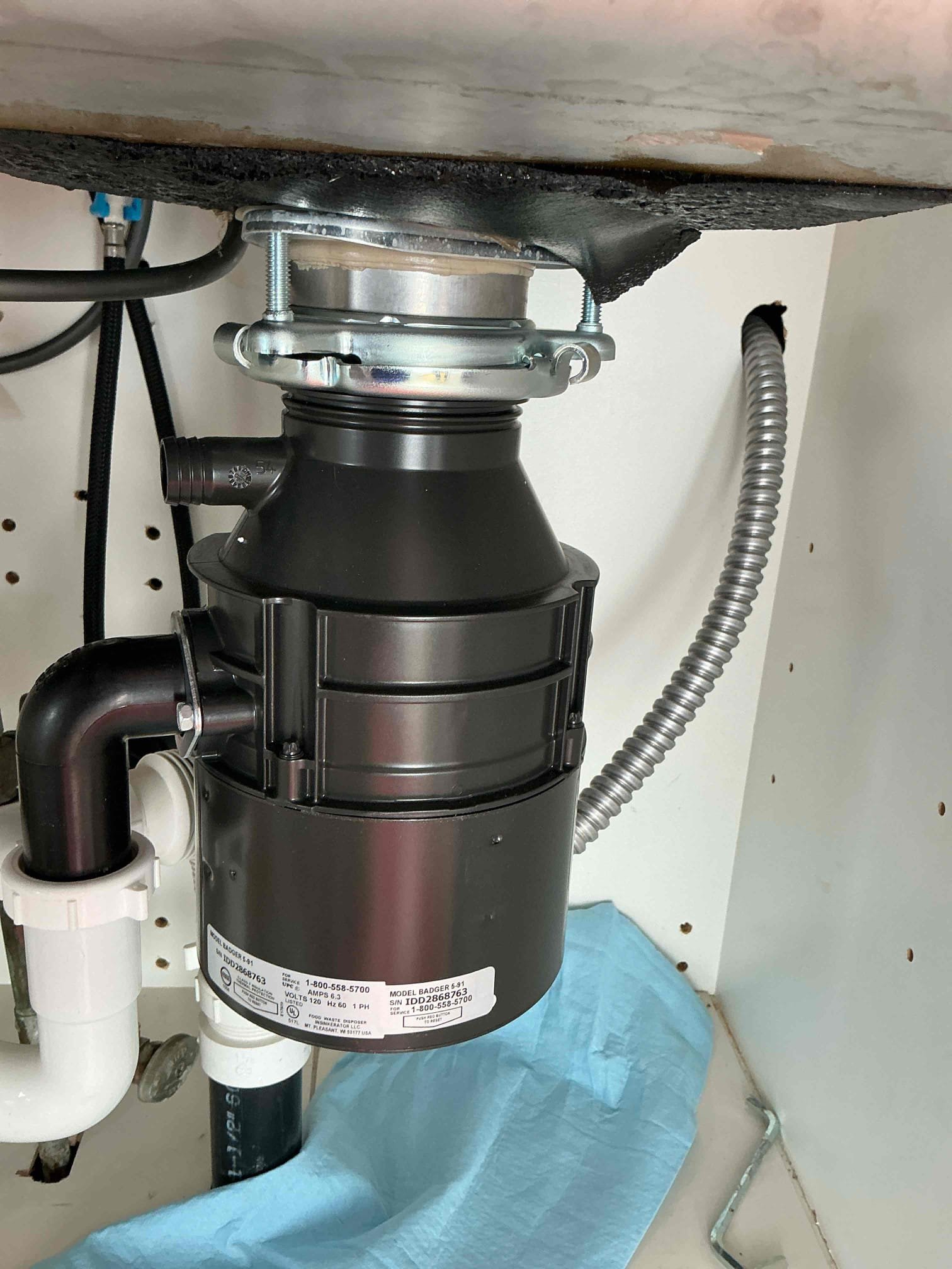 Customer called us out for a leak under the sink during our visit we performed a thorough evaluation of the sink area and identify the root cause of the leak as a failing garbage disposal unit given that the existing disposal was leaking . The only viable solution was a full replacement. The customer agreed to proceed with this replacement we supply and installed a new half horsepower badger model five disposal unit after installation we thoroughly tested the unit to ensure it was functioning perfectly and we confirm that everything was working as intended. Additionally, while on site we measured the home water pressure and found it to be high at 120 psi we provided the customer with a separate quote for installing two pressure reducing valves PRV’s to help regulate and maintain optimal water pressure in the home