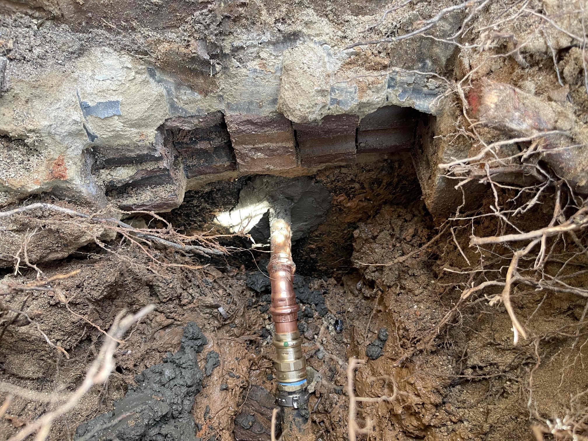 Black polybutylene water service had developed small leak on exterior of house due to the angle it was installed at. We cut out the pipe coming through the wall. Ran new copper pipe back through the wall and connected it to the existing lines bi5 inside and outside the house. Sealed both sides of the penetration with hydraulic cement, and spray foamed between the concrete. Pipe did have a PVC sleeve already going through the concrete. Tested to ensure a leak free installation. No further issue at this time. 1 year warranty on repaired section only. Thank you for choosing Chen plumbing. 