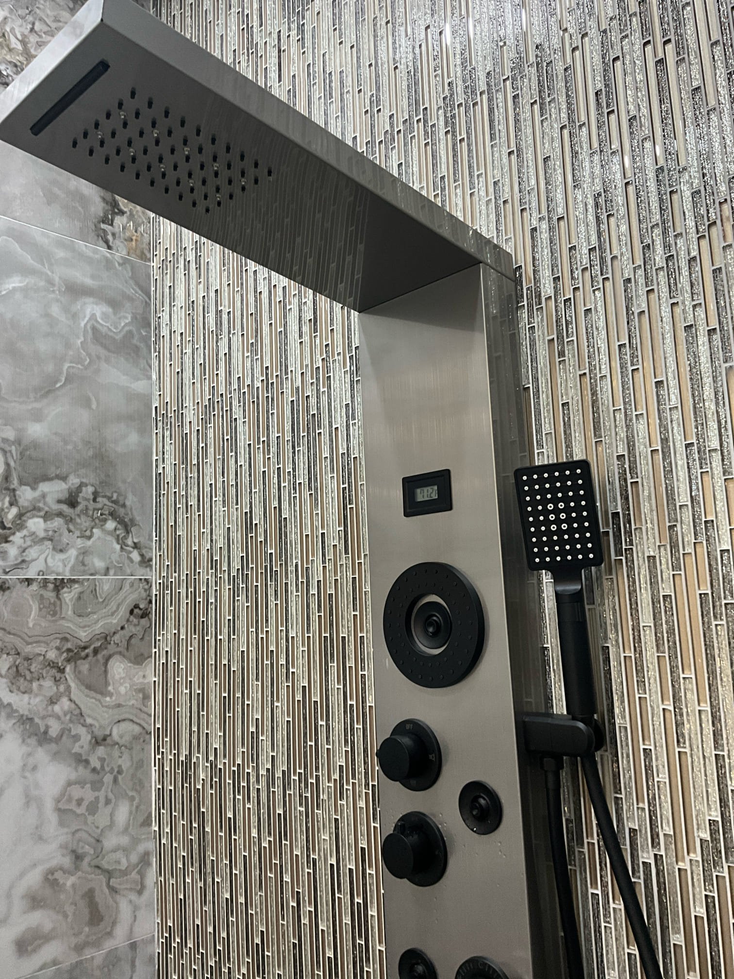 Call for water leaking from shower panel.

Arrived and inspected unit. Water was on when I arrived, no leak present. I tested all the functions and features in all combinations available to attempt to replicate leak. I ran water from shower head for nearly ten minutes. I manipulated the shower handle to see if the housing could be fractured or defective, leaking only during use. I tested with unit off of wall, and on wall. I called Amanda, the assistant of Mr. Syed, and asked if there was a certain combination of settings I could stress test. I tested functions with the knobs halfway between features. Tested with water on, but features off. 

With the exception of turning the hand held spray directly at the seam between the unit and wall, I was unable to see any kind of water escape. If problem occurs again. Please annotate which settings were on, approximately how long the shower was running, and at what time. It seems likely that the shower panel may have a defect or some kind of man