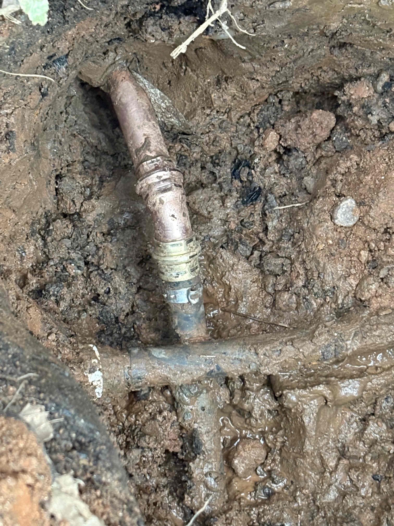 Client called us out due to their guys while working finding/hitting the main water line that had a pinhole in it right at the bend in the pipe before going into the home. There was just not enough pipe sticking out to be able to fix it just outside, so we removed that pipe from the foundation, drilled the hole out, then inserted the new type L copper pipe with tape around the pipe as a sleeve. Connected the copper to the 3/4” black poly outside and then reconnected to the copper inside. Did have to cut small hole in basement Sheetrock to do repair, but was able to put an access panel over the hole. Hydraulic cemented both inside and out after testing. Also backfilled hole for client as their client was worried about the water line being exposed in the cold temps. 

They are good to go, no more leaks. 

Bill out. 