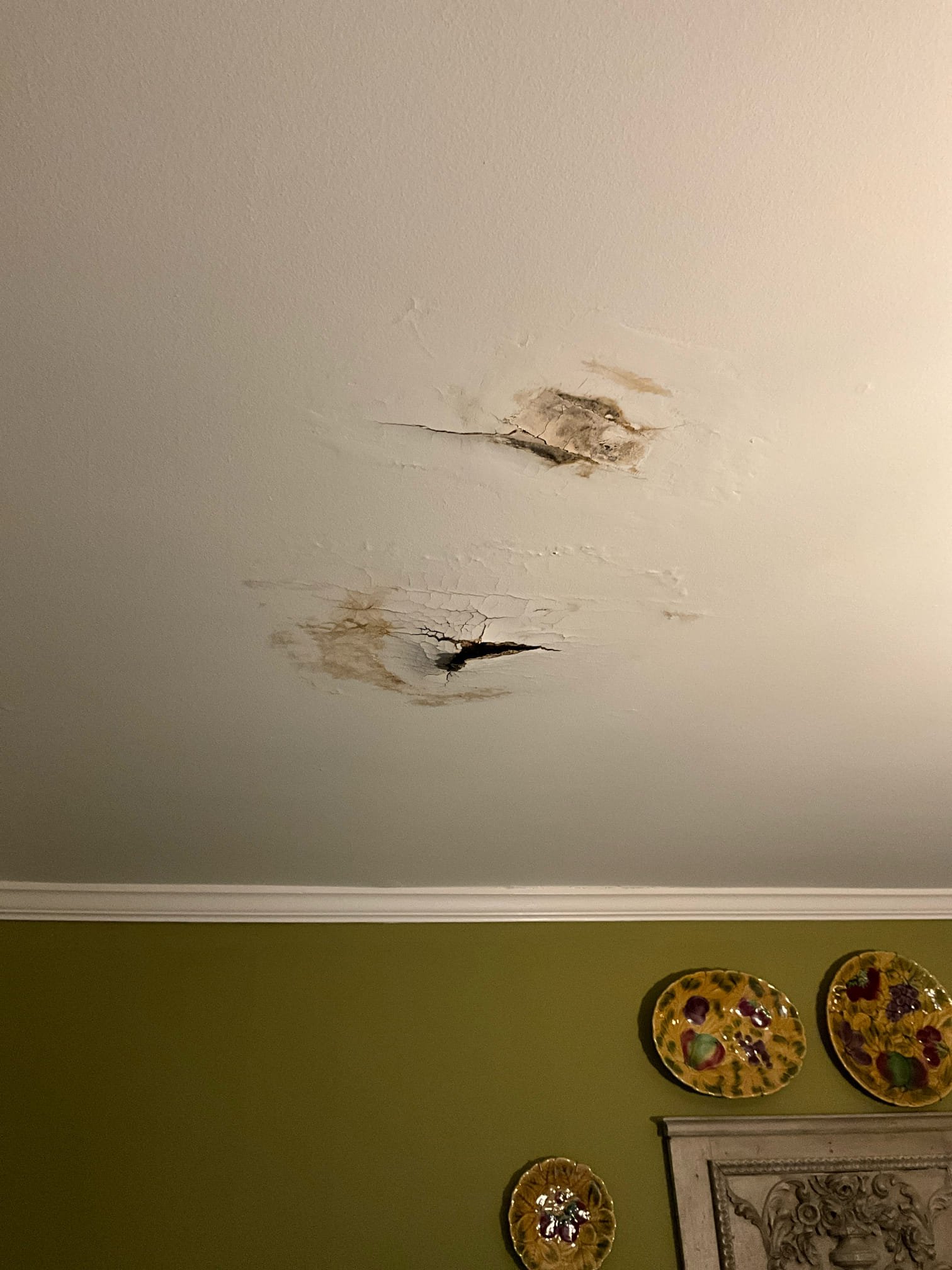 Call for leak in ceiling in dining room.

George stated that the leak has occurred sporadically over a year. He also stated that he has used small auger or retrieval tool to remove blockages from this shower in the past when it was draining slowly, including recently. After he removed hair the ceiling stopped dripping. 

When I inspected the master shower I found that the waste line and tile shower line are in poor shape. It appears that the seal between the shower and waste line is bad. Due to the nature and condition of the shower pan and tile, it will likely need a new shower pan. 

Today repairs were declined, and George wanted an opinion on what would cause this type of damage in order for them to decide which route to take for repairs and replacement.