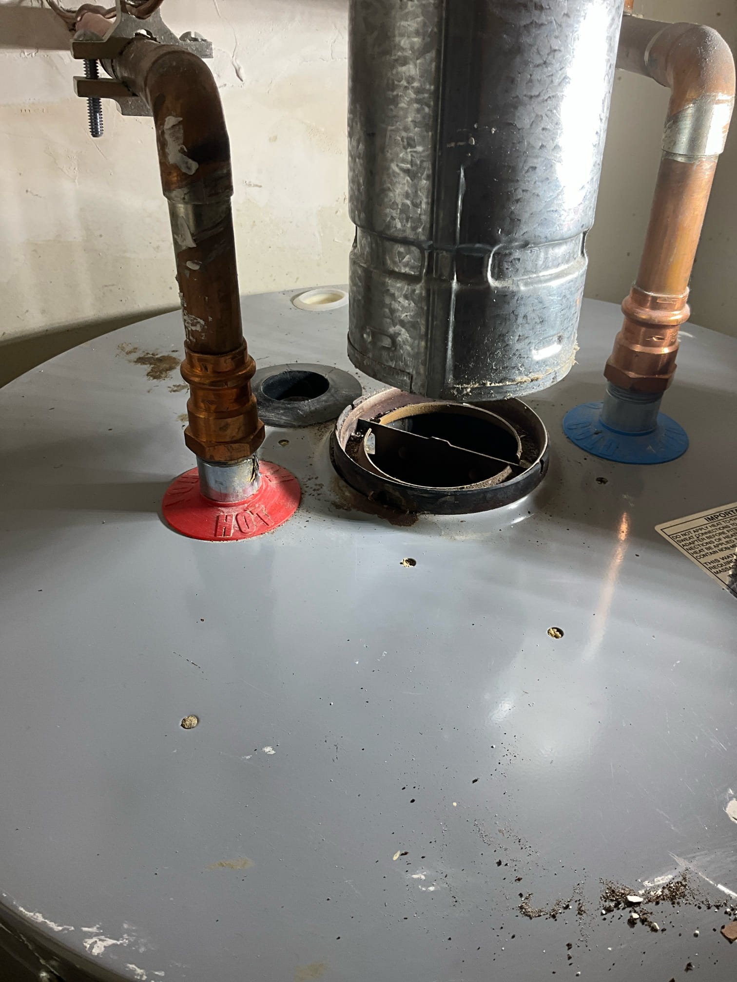 Adjusted water heater exhaust vent to accommodate the draft hood. Existing draft hood was not installed after roof damage and reconstruction. Lifted exhaust and verified exhaust line in attic. Installed new draft hood and verified unit is heating and exhausting properly.

Price adjusted as vent work in attic was not required.