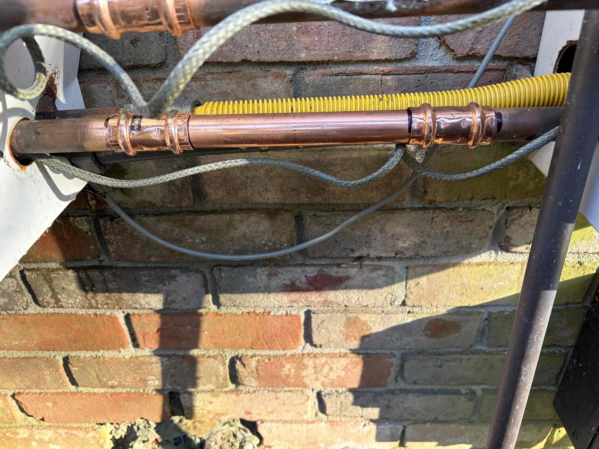 This customer he had a pipe on his water heater tankless outside units. He has two eyes outside. They are from 2007. I strongly recommend he replaced both units due to the fact of how old they are. They are almost 20 years old however they still work would I recommend is to swap them out for either a navien or a Rianni, however, the customer just wanted the pipe fixed at this time the hot and cold cold water lines had popped and split so therefore I installed a new section of pipe on hot and cold lines had to bend back the cover just a tad, the customer was OK with it. I was able to put the screws back for the skirt. In addition to that I reformed the installation of the pipes to ensure that it would not happen again at this time. Water is back on the unit, so is the gas tested the tankless before we had left to ensure that the unit was still working at this time, there are no leaks. Water pressure is at 55 psi