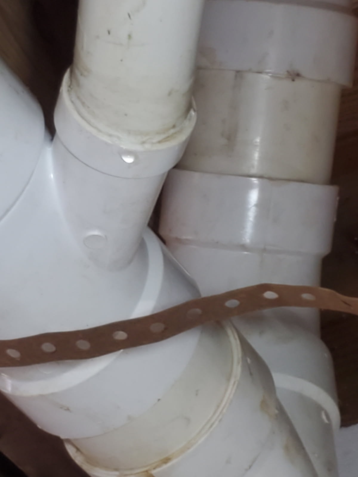 Client called us out due to a drain we just put in having a slight drip at the hub, and after initially calling their hose bib line burst under the carport. 
The drain pipe had pulled out of the hub and was barely inserted which is why it leaked. To fix we used a 45 offset to make the angle better and glued together. No leaks after testing. Good to go.  

We also cut the pvc side of the old hose bib line and capped per customer request. Let the pvc glue dry for about 30 minutes then turned water back on to test. No leaks. 