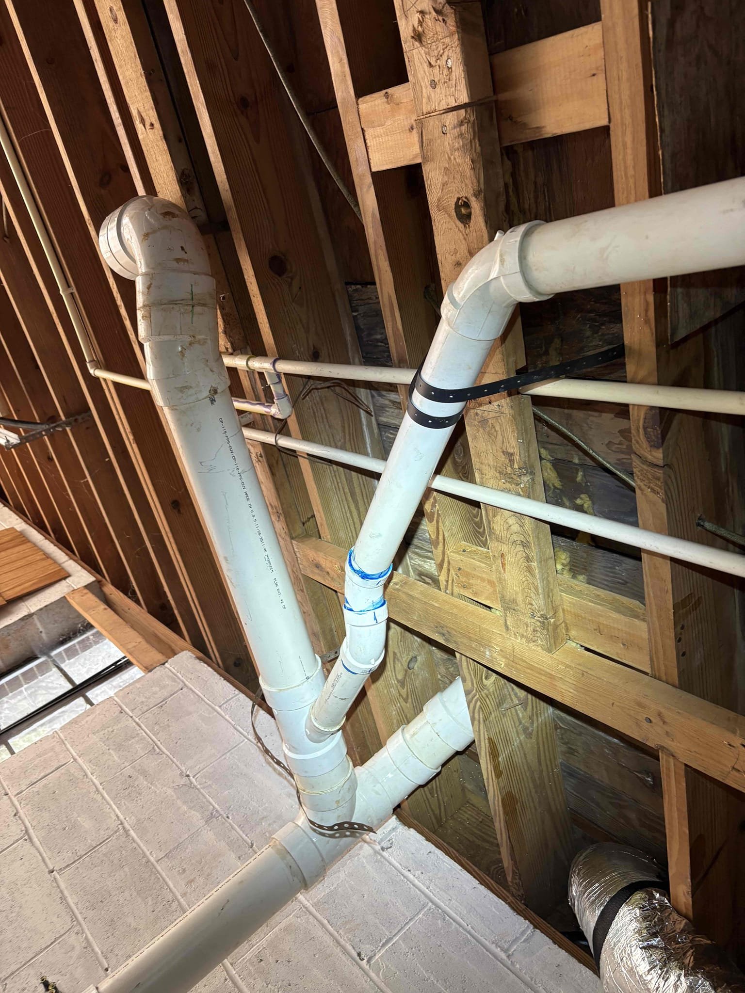 Client called us out due to a drain we just put in having a slight drip at the hub, and after initially calling their hose bib line burst under the carport. 
The drain pipe had pulled out of the hub and was barely inserted which is why it leaked. To fix we used a 45 offset to make the angle better and glued together. No leaks after testing. Good to go.  

We also cut the pvc side of the old hose bib line and capped per customer request. Let the pvc glue dry for about 30 minutes then turned water back on to test. No leaks. 