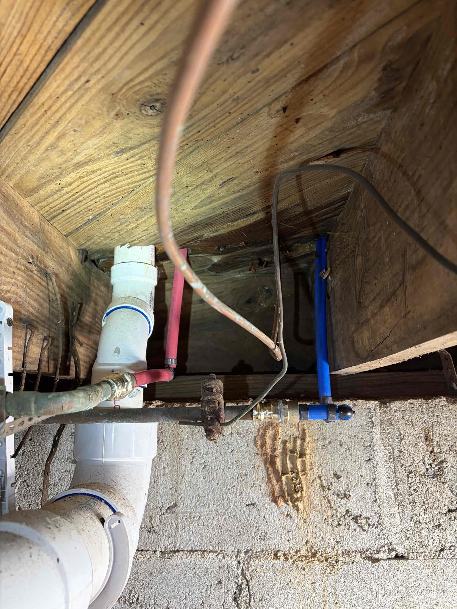 Repipe the hot&cold water line for the kitchen sink
The water line coming from the crawl space is 1/2 in pipe then converts into 3/8
Will need to make all 1/2 pipe.
The leak is coming from the service stop however the pipes are bent and I will not be able to reattach properly 
So for this job, we re-pipe the hot and cold water lines for the kitchen sink. The previous waterlines came in as 3/8 rather than half inch so therefore we installed new half inch pipe and pecks so we can feed it down into the crawlspace. make sure everything was crimped properly to ensure a leak free connection. There was a saddle valve on the copper pipe so therefore I added a quarter inch Shut off valve however I do not know what it goes to however, I did reconnect the valve on but kept the shut off valve off at this time. There are no leaks on any of the pipe connections. The pressure is at 120 and I advise the customer to replace the pressure reducing valve as soon as possible. The pressure being this high c