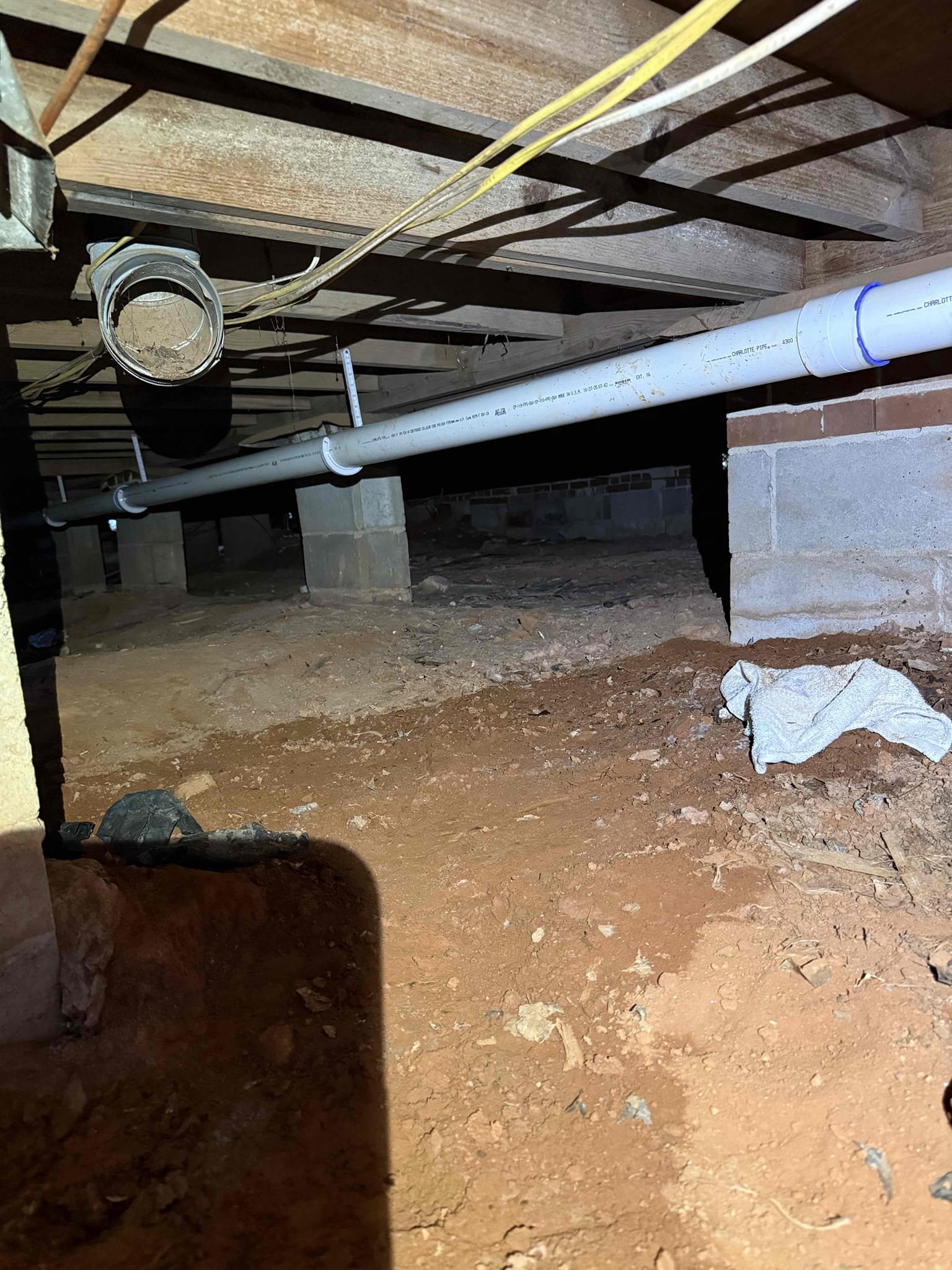 Started by removing cast iron piping in crawl space and began to replace with PVC. Will return tomorrow to finish last portion in crawl and start sewer line outside. return the following two days to continue work. Completed the removal of cast-iron in crawlspace and replaced all with 3 inch and 4 inch PVC used J hooks and two by fours to support and strap drain work. checked all areas for leaks and proper pitch. In the yard replaced 4 inch concrete sewer line with 4 inch PVC laid line to appropriate depth and reattached to concrete tap approximately 8 foot deep with approved material methods. After piping was all connected, ran water to ensure for proper drainage function, backfilled trench and hole to rough grade. Repaired section of water service that was hit during excavation. Also added 6 inch cleanout at tap and 4 inch clean out at house. Customer requested house clean out be higher for future landscape work.