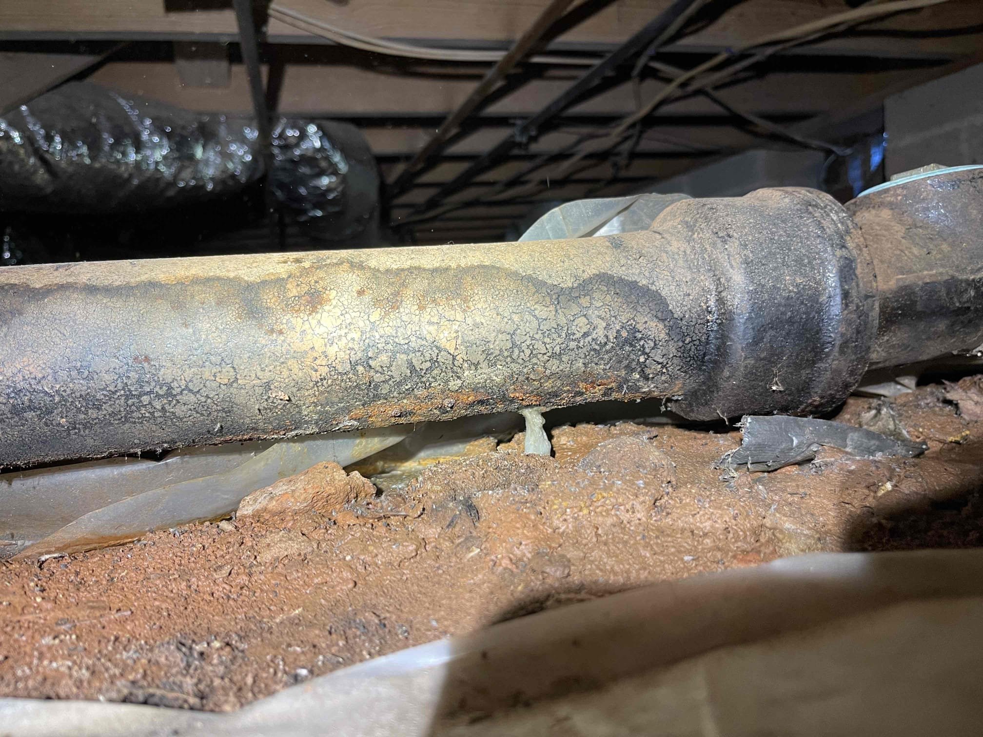 Came out for a drain smell near the laundry and powder room. Upon investigating the crawlspace, we found kitchen drain line was rotted through, and was leaking sewage into the crawlspace and created a strong odor. We also found the hvac vents to the powder room/laundry area are full of water. I believe this is creating the smell in the bathrooms, and also has the smell of the sewage radiating up through the floor under the kitchen. Referred restoration services to deal with the sewage issues in the crawlspace. Left quote to replace cast iron in crawlspace, drain have multiple sections that are flat or back pitched.