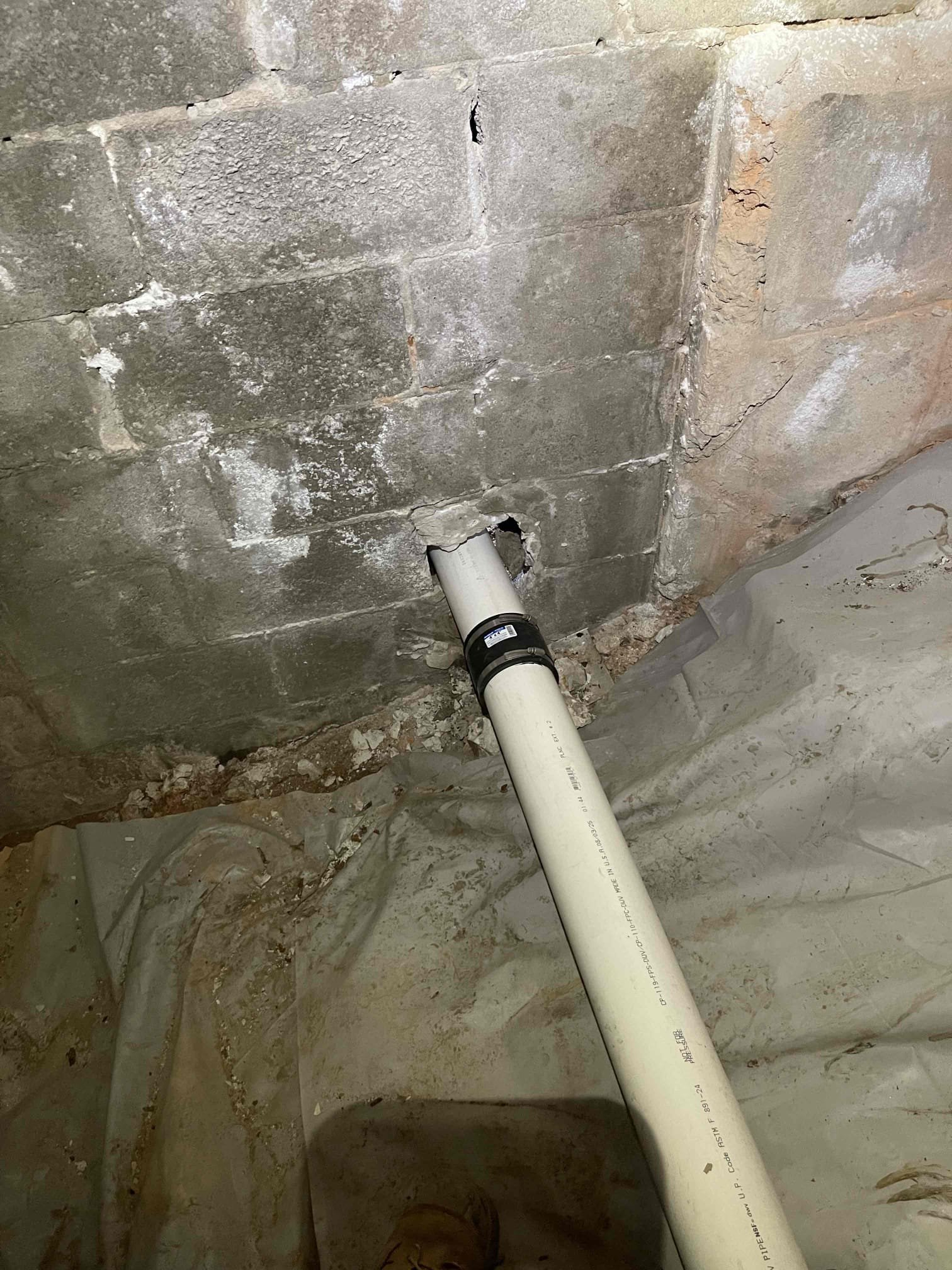 Jackhammered front steps and concrete walkway. Dug down 6 feet to the line. Found cast iron line was broken at the foundation wall and was rotted out on bottom side. Removed cast iron and replaced with pvc. Installed new two way cleanout. Sealed foundation wall with hydraulic cement and a rubber sealant in the exterior. Code enforcement arrived and we had to pull a permit for the repair. Pulled permit and returned with inspector. He wanted a hydrostatic test done on our 10’ repair. We left and found an inflatable test plug. Stopped the line up and filled it with water. Confirmed no leaks in the line. Inspector gave us the go ahead to back fill the repair. Backfilled the removed soil, tamping every 12 inches. No further issue at this time.