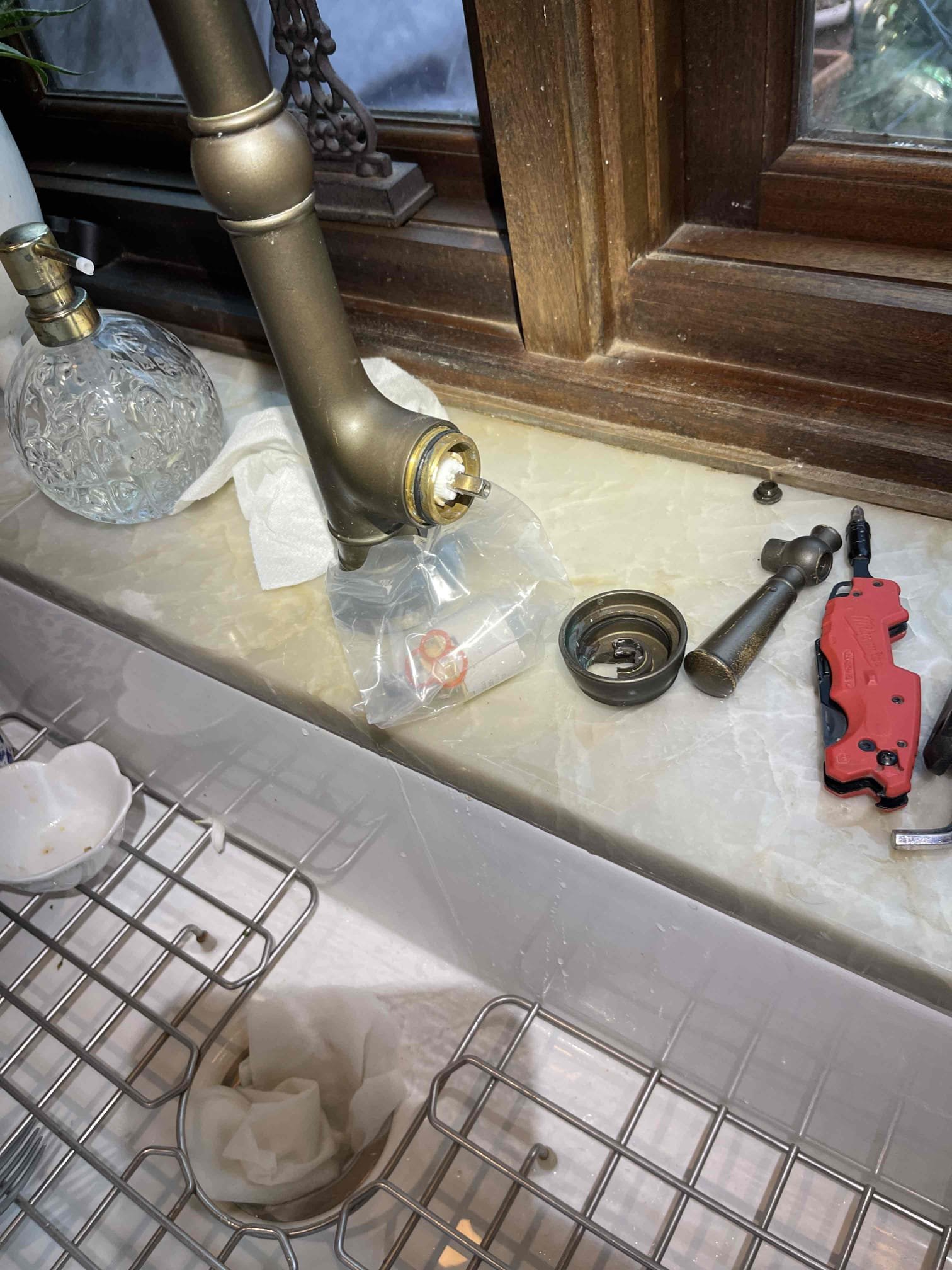 Replaced customer supplied kitchen faucet cartridge, and replaced handheld shower sprayer with customer supplied sprayer. No further issue. 