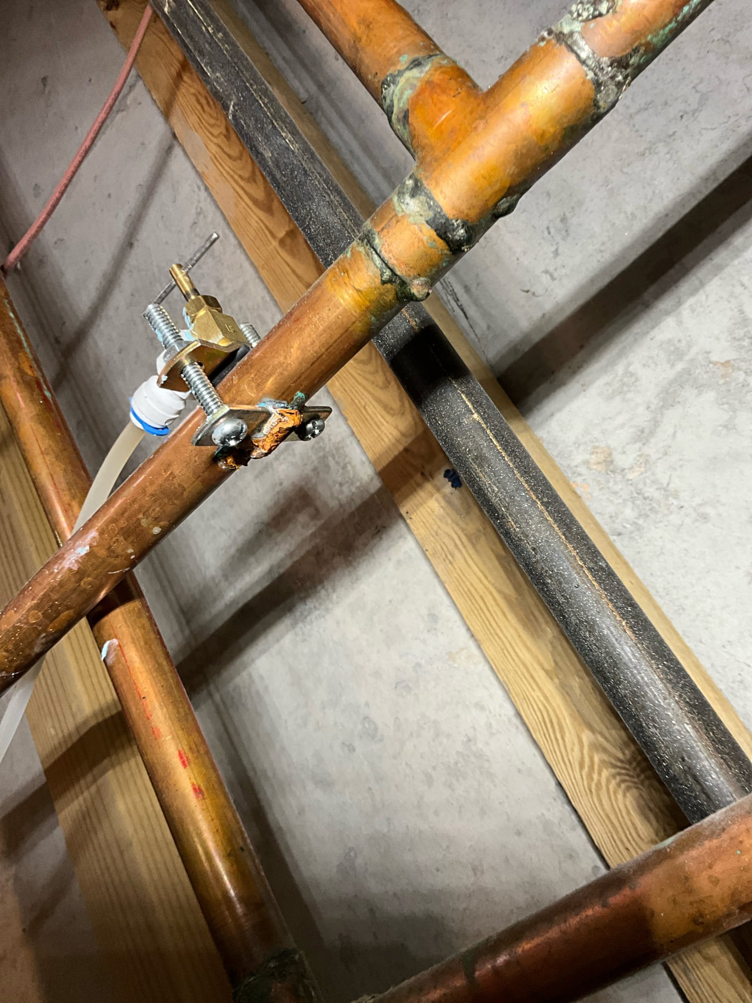 Call for leaking water heater. 

Arrived and met with Mrs. Zhu. She showed me two water heaters in the basement. One is 30 years old, and another is 12 years old. When inspecting the water pressure, I found it to be over 115psi at approximately 3pm on a weekday. Safe range is 40-75psi. Anything over 80 results in damage to plumbing system and home. 

When inspecting the water heaters I found multiple issues and concerns. Both units are actively dripping from the interior tanks, resulting in water accumulation on the floor. There is also a dripping tee on the copper line, a saddle tap fitting with significant corrosion, a small gas failure, a leaking thermal expansion tank. All issues will be resolved with water heater replacement. 

Pressure regulating valve is located in ceiling in room to right of bottom of the stairs. 

I also discussed options to help address copper pipe pinhole leaks, and I believe a whole house water filter is a good option to help decrease continued corrosion. I