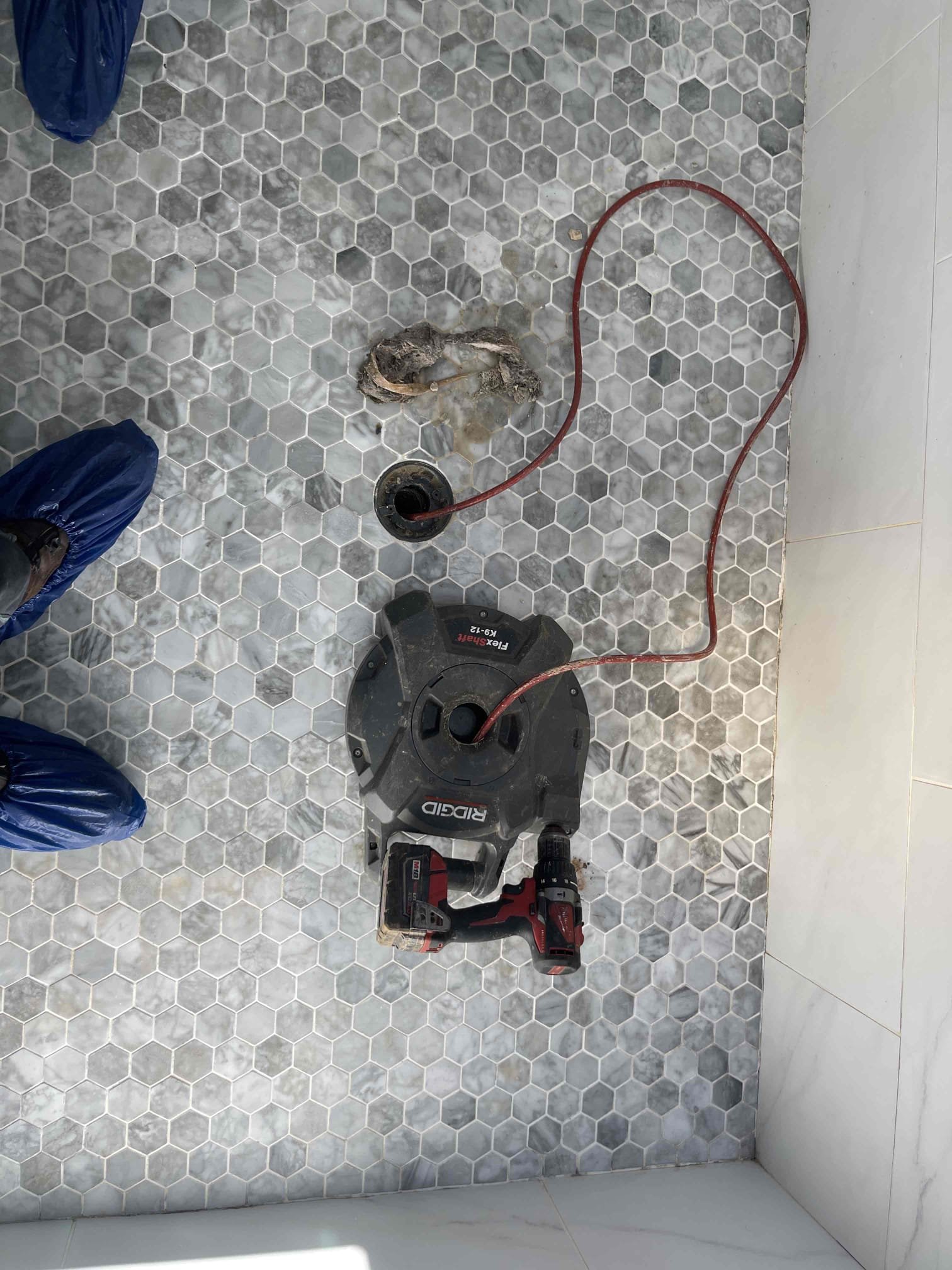 Came out for a clogged shower and a kitchen faucet having temperature issues. We snaked the shower with a flex shaft drain cleaner. Removed large hair blockage and cleaned out all of the soap scum. We ran water at the kitchen sink and found it would start cold, turn hot, and randomly change back and forth from hit and cold when the cold water was ran. We went down to the unfinished basement and felt the cold piping back to the water heater. Found the swing check valve at the water heater was allowing hot water to travel up the cold water line and mix into the cold water system. Received approval to replace it. Cut out the old swing check and found the door inside was stuck wide open and this was causing the issue. Replaced with a spring check valve, no further issue at this time. 