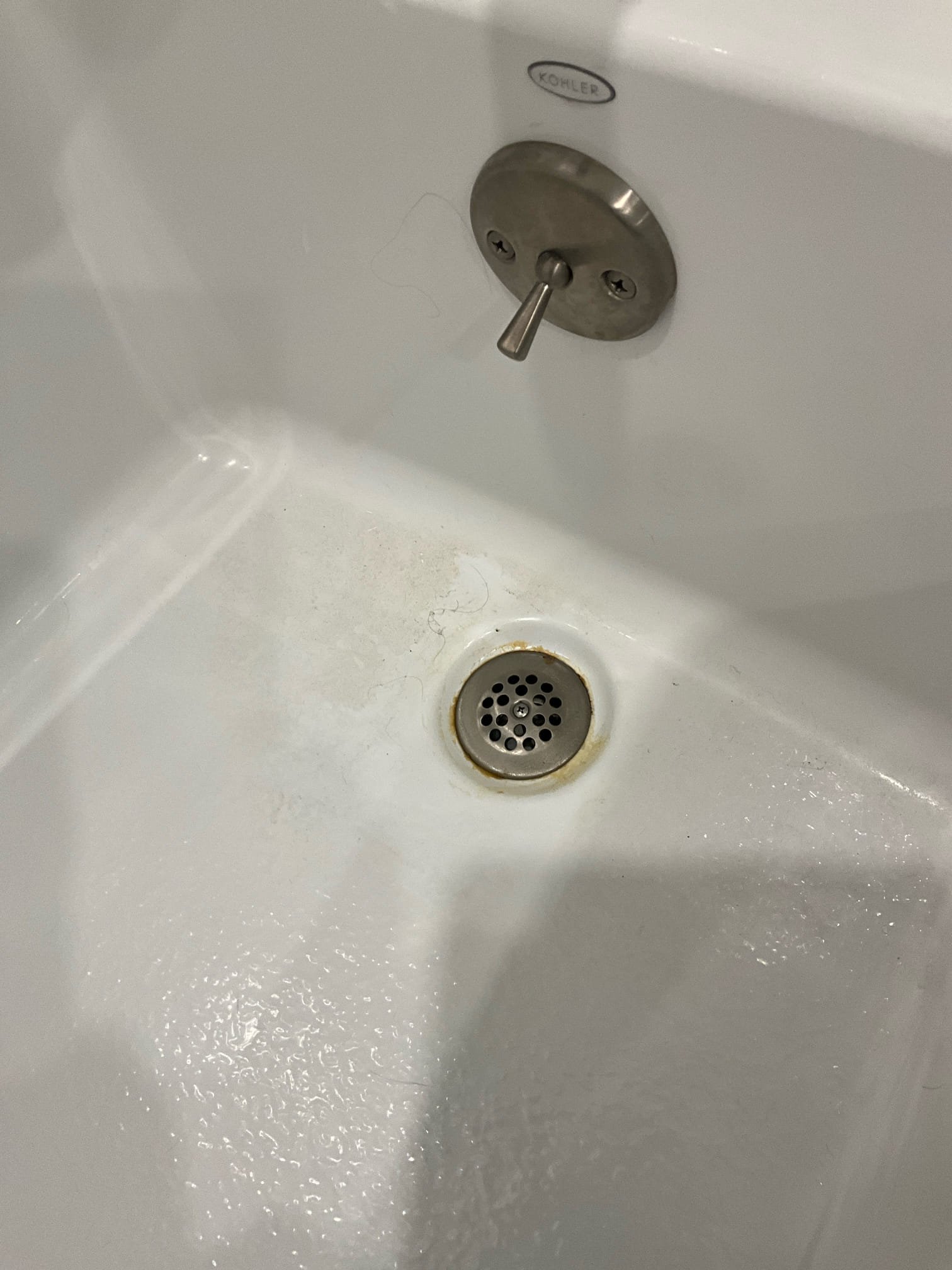 Customer had a small ring of discolored water around the tub shoe of basement tub. Customer had concerns that the tub had maybe backed up. Pulled the hair strainer and found a sticky residue that was discolored from water sitting around the tub shoe. Informed customer that the tub shoe likely just needs to be cleaned and that there is no imminent signs of a blockage at this time. Tub drained normally.