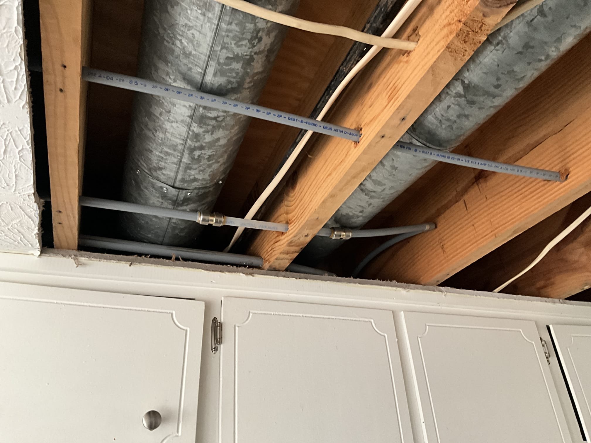 Customer had a leak of unknown origin in ceiling above garage. Upon arrival, found that a lot of water was in the ceiling, walls, and floors between rooms from the garage, to the kitchen, to the foyer. Large sections of drywall had been cut already to access the plumbing. Immediately noticed a large amount of grey poly present in the home. Found a leak occurring from a tear in the grey poly. Gave customer options to repipe the whole house, or repair just the section with no warranty. No warranty can be given on poly repairs due to the nature and volatility of the pipe. Customer declined whole house repipe and opted for the repair. Reliable Restoration was on site per Braulio. Tested leaking section in garage and confirmed no further leaks were in the area at this time. Customer also wanted us to check the kitchen area but Reliable had already encapsulated it. Informed customer of everything written above. 