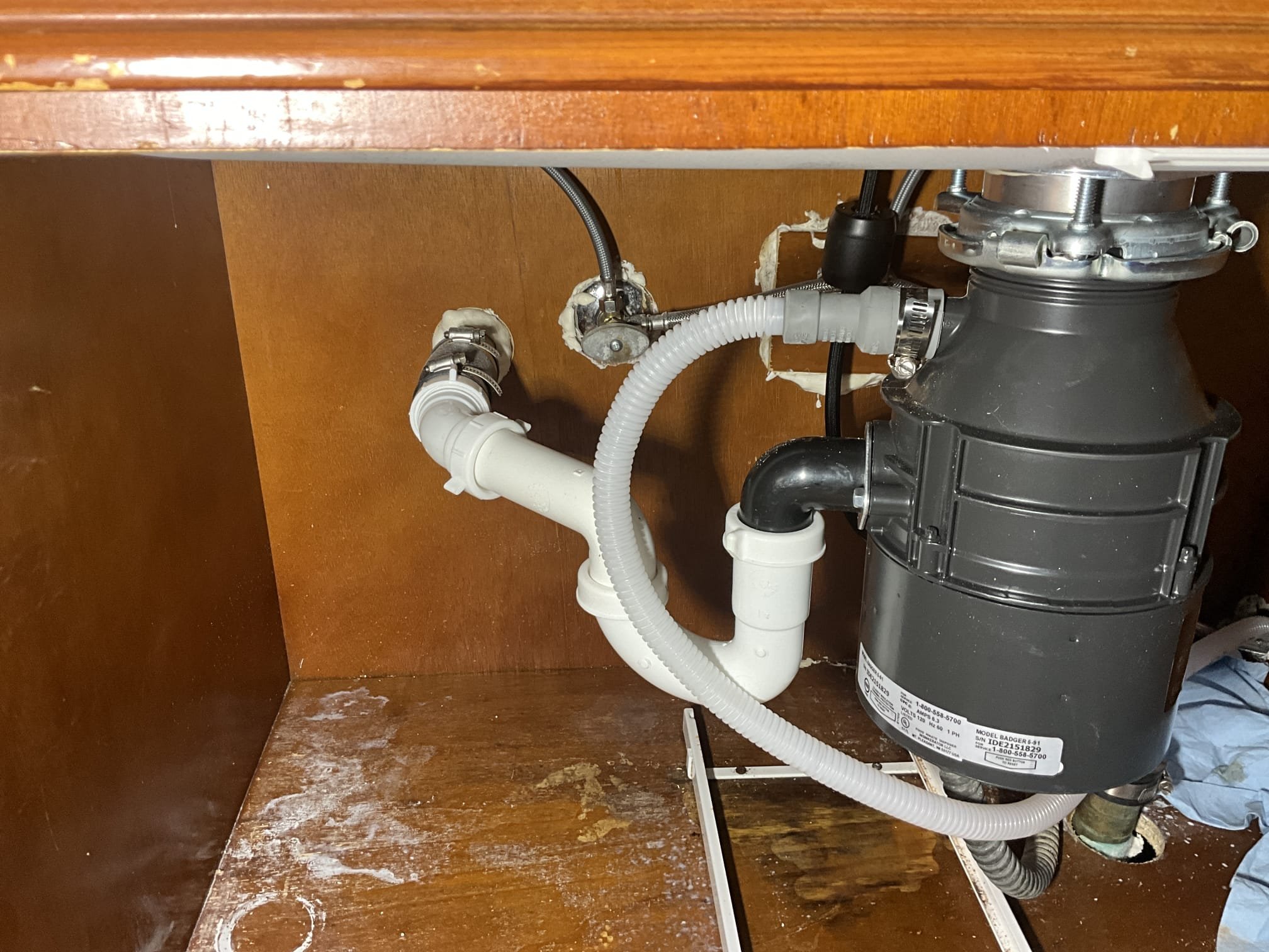 Call to reconnect sink and components after new countertop install.

Arrived and met with Ms. Christina and Keith. New countertops were installed, but plumbing was left off. Further, the hot side shut off valve was leaking a moderate amount. 

When inspecting existing components and install request, I found: Faucet was a new glacier bay single handle pull down style. All components present and undamaged. Garbage disposal had rust on both organic collar, and the mounting bracket. Gasket was dry rotted. Shut off valve needed to be rebuilt, and debris removed. Drain lines are copper, and were configured for double basin shallow sink. 

I installed provided faucet. Rebuilt hot side shut off valve, removed gasket debris and cleaned threads. Returned water service to home. Installed new garbage disposal and mounting bracket. Direct wired unit in, and replumbed drain line to accommodate single basin deep sink. I elected to cap secondary line off, as dish washer drained through disposal, and d