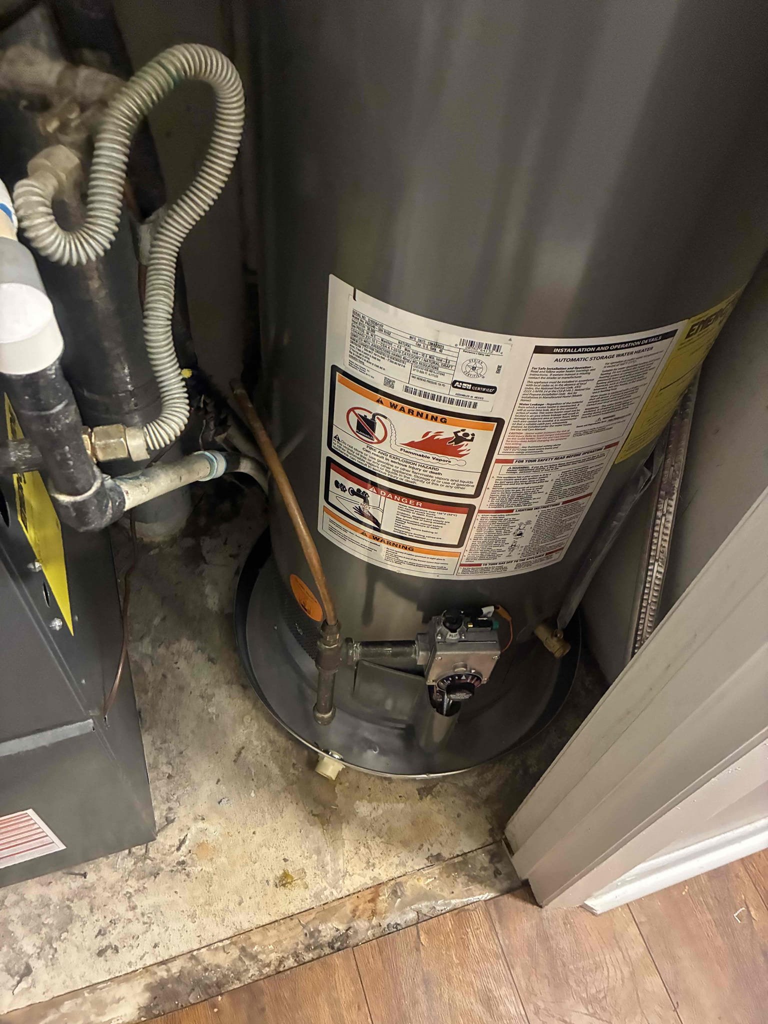 Customers water heater busted at back seam. Gave options to replace heater. Replaced water heater with Rheem 40 gal gas water heater. After replacement, checked for leak and proper function. Pressure is set at 50 PSI. 