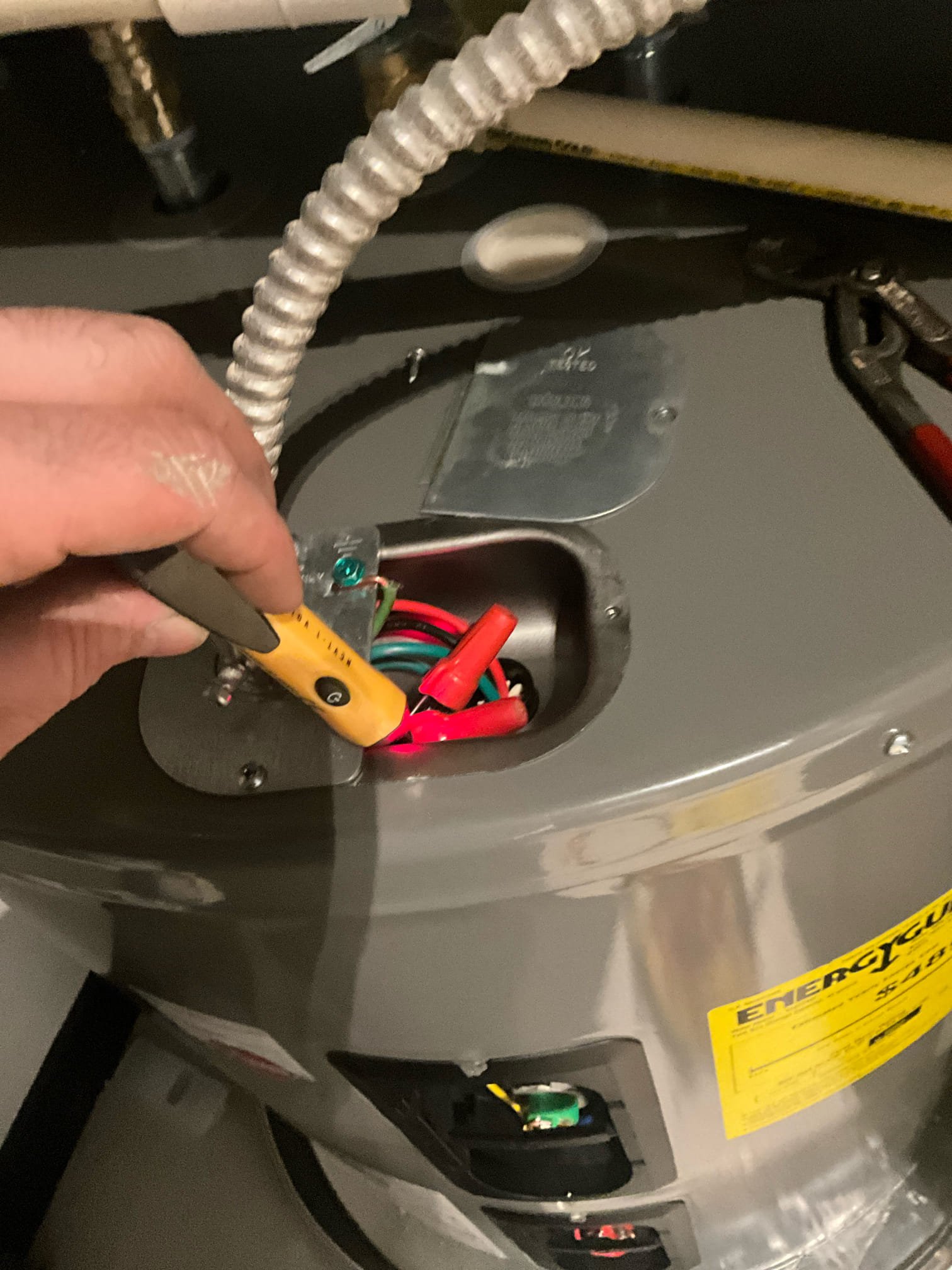 Returned and removed the old 50 gallon lowboy water heater and installed a new 50 gallon lowboy electric heater. Reconnected to existing water, electric, and t&p lines. Found a leak on the lower element from where a gasket pinched. Drained the tank back down and replaced the gasket. Tested all work to ensure proper functioning and no leaks. None were found. Waited for heater to produce hot water. 