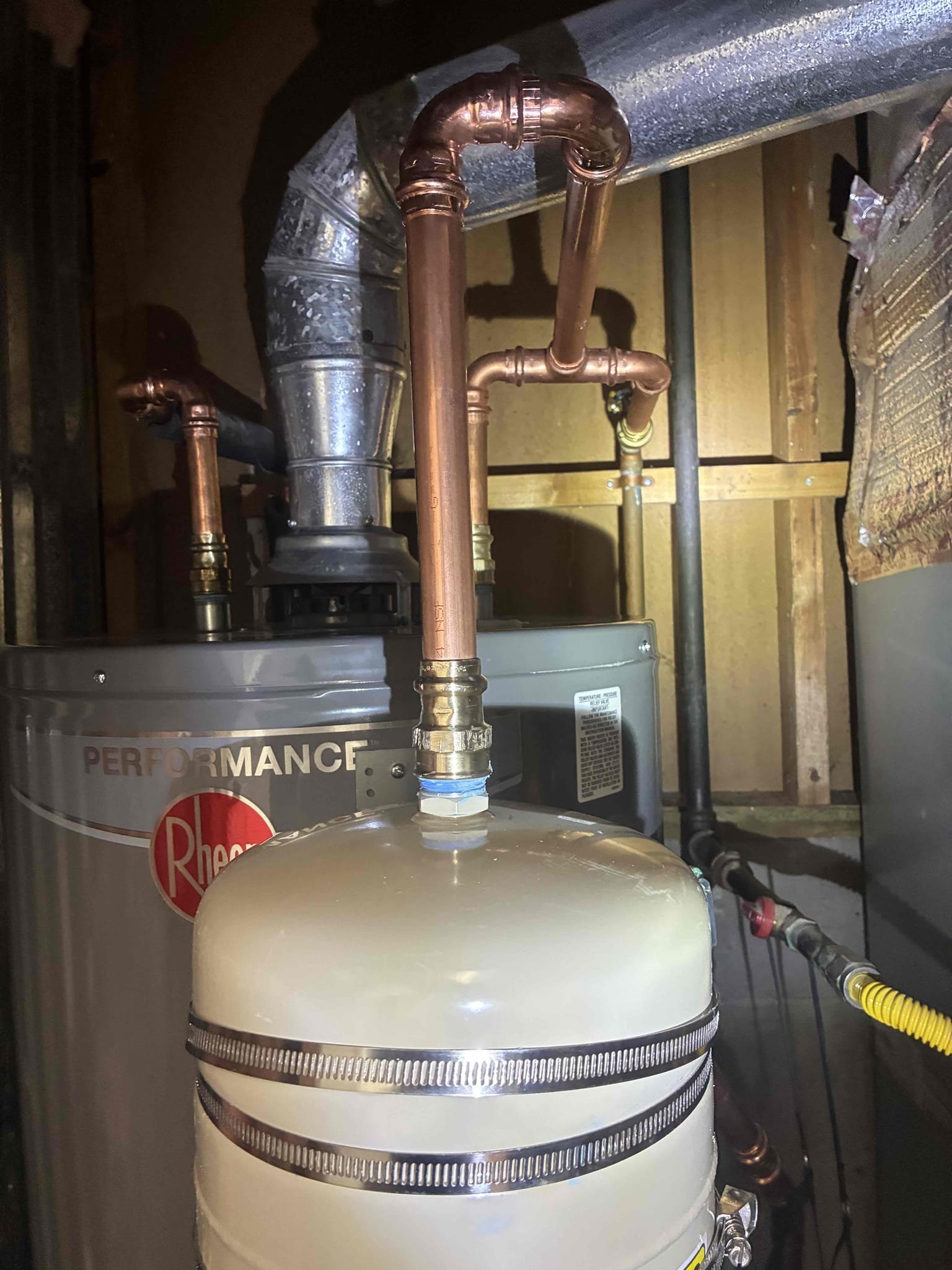 Customer had 40 gallon gas water heater leaking at base. Reviewed work and gave customer options for replacements of heater. Replaced heater with 40 gallon Rheem gas heater. Replaced ball valve and thermal expansion tank with bracket also added pan under heater. After work was completed checked for leaks in proper function, while running water in kitchen sink to remove air from hot line. drain line began to back up unexpectedly. Gave prices to run drain equipment in order to clear line, was unable to clear from underneath sink. attempted to clear drain line from roof access in vent but again was unable to clear. gave customer options for jetting from roof, but customer wanted to wait for further work explained to customer about Pricing adjustment for Jetter work and also clarified with customer that drain is still not draining properly.