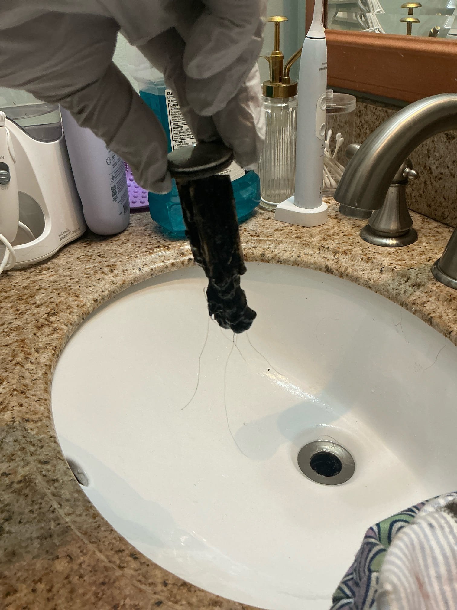 Customer called about slow draining lavatory in upstairs guest restroom and constant drip on master restroom left shower valve. Pulled pop-up assembly on guest restroom lavatory and cleaned debris. Reassembled lavatory pop-up and tested. Drain flowing properly. Pulled master restroom left shower cartridge and replaced with new cartridge. Tested and left in good working order.