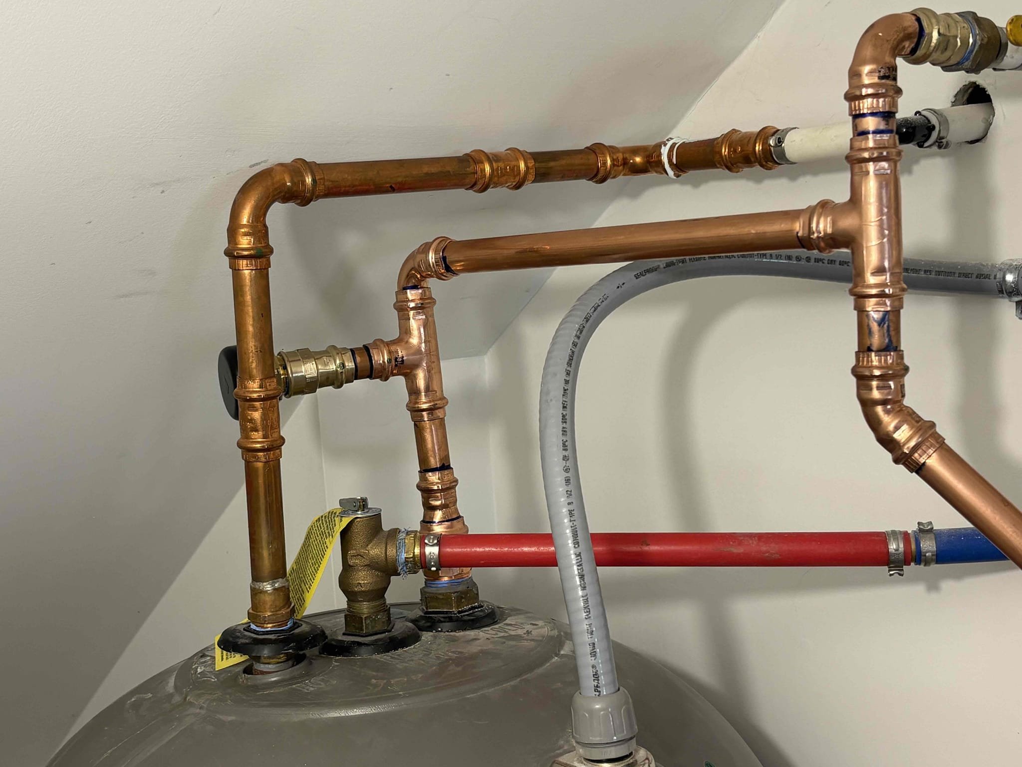 Client called us out due to a leak on their 10 yr old 50gal marathon electric water heater. I determined the leak was coming from the vacuum relief valve just above the cold water inlet of the water heater. Did not see any more leaks on the unit. 
We repiped the cold side of the water heater with all new fittings, new vacuum relief valve, and new properly supported thermal expansion tank, pumped up to match home pressure. After all work was complete fill tank back up and got air out. Put the electrical disconnect back in and powered on the water heater. No more leaks, everything seems to be working as it should be. 

1 yr warranty