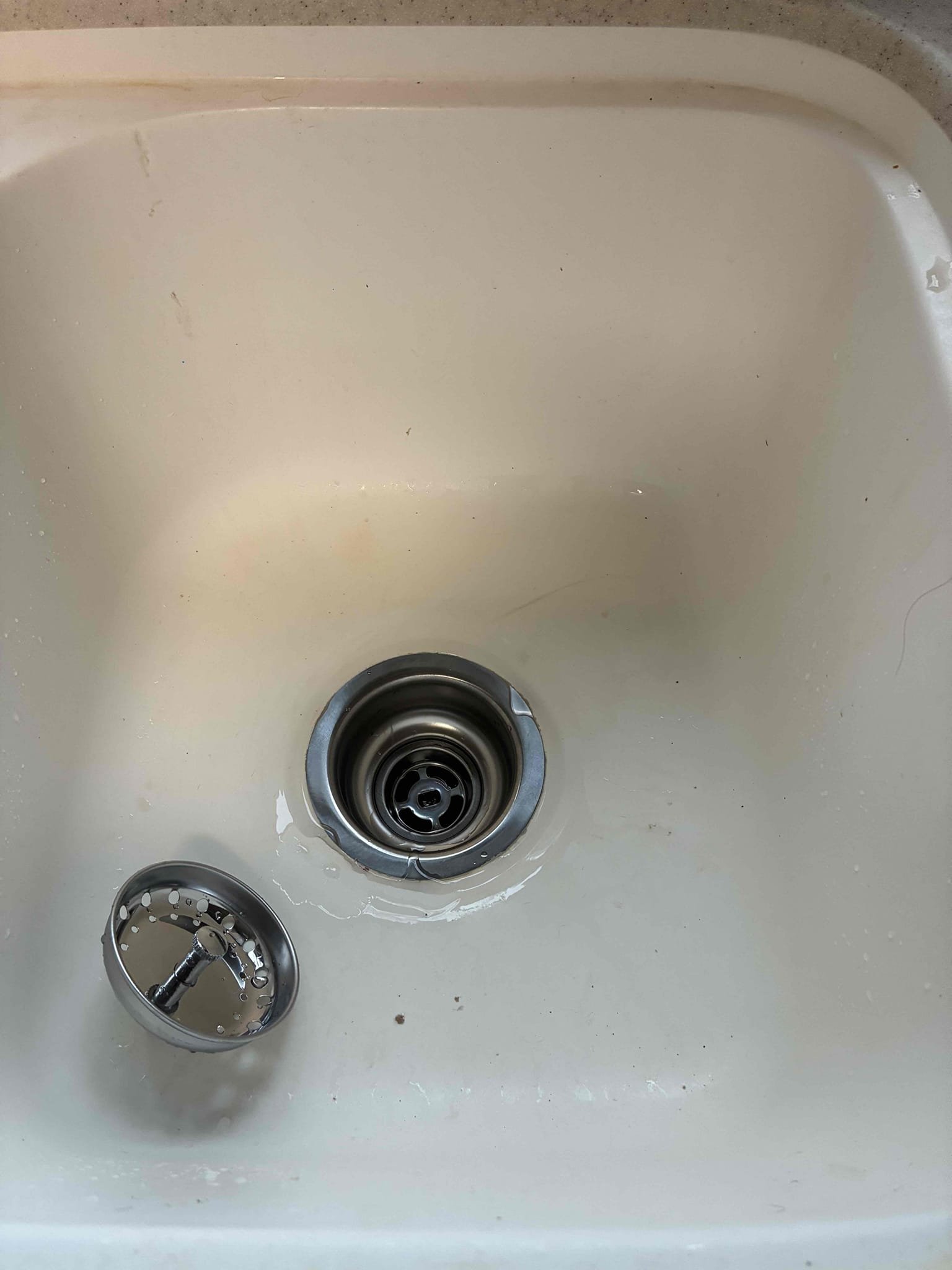 Take apart tubular pipe and fittings from below kitchen sink and install new basket strainer. Reconnect drain and test for proper operation and leaks. No leaks found after work completed.