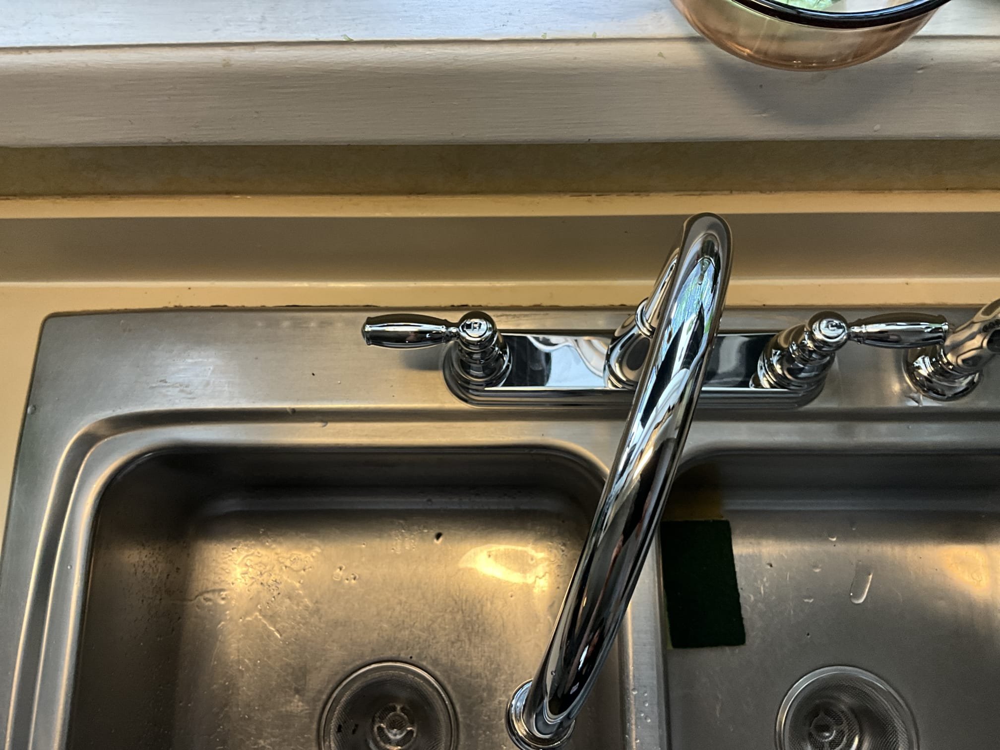 Returned and installed customer supplied kitchen faucet with side sprayer. Cut out the old gate valves below the sink and installed new supply lines, escutcheons, and stops. Reconnected to the new faucet and tested work to ensure proper function and no leaks. None were found.