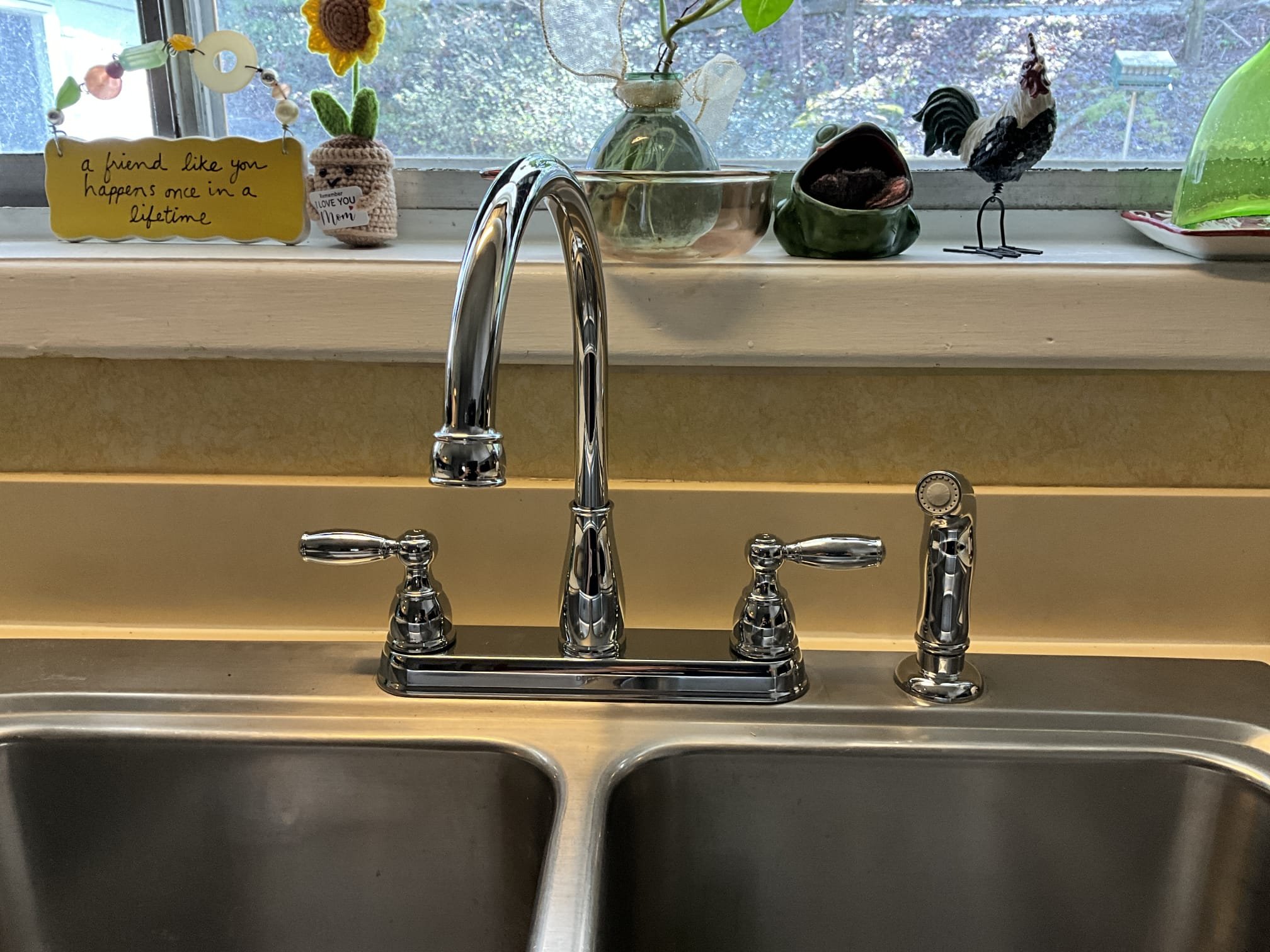 Returned and installed customer supplied kitchen faucet with side sprayer. Cut out the old gate valves below the sink and installed new supply lines, escutcheons, and stops. Reconnected to the new faucet and tested work to ensure proper function and no leaks. None were found.