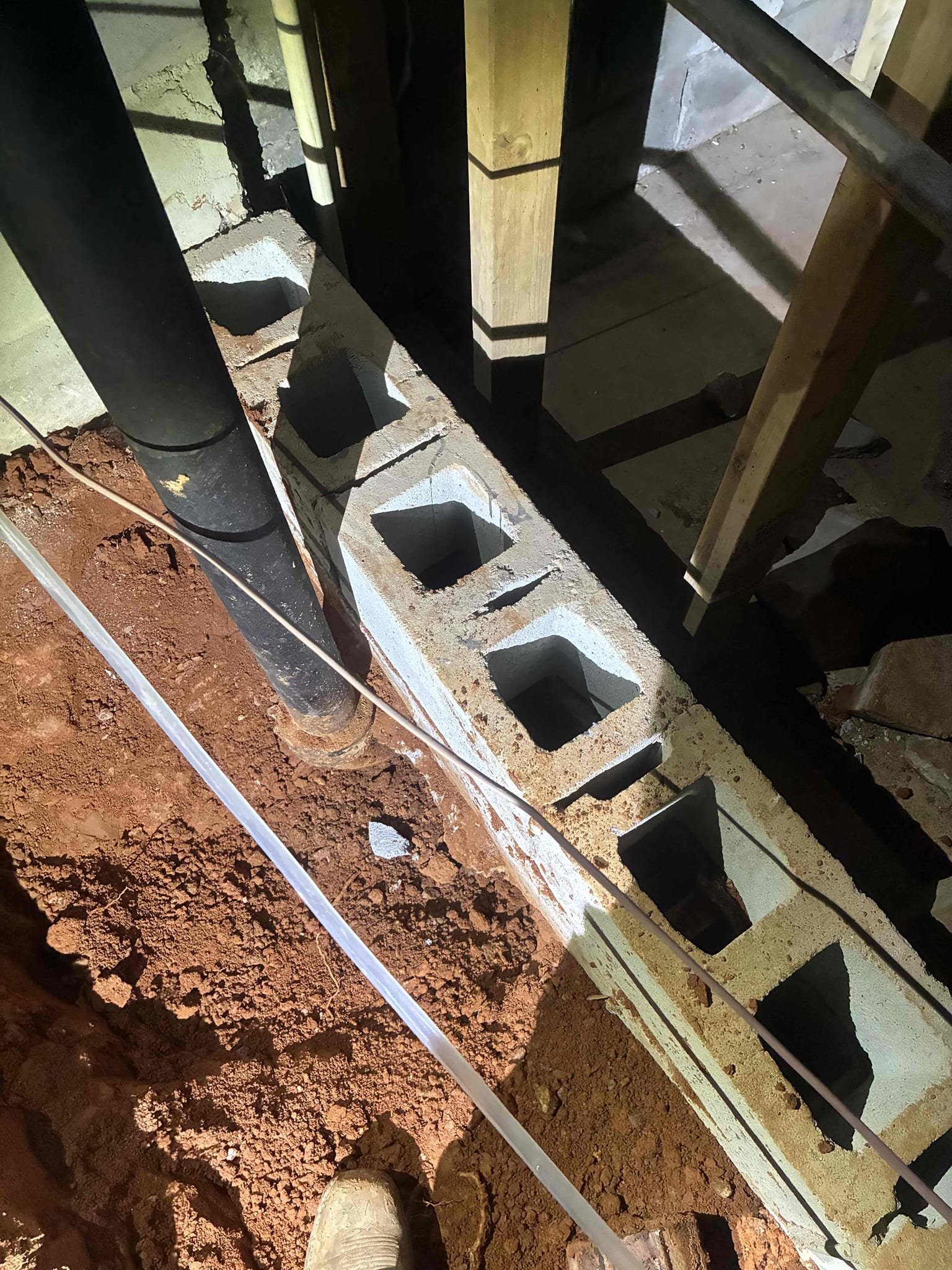 Today will start and finish of relining process. Dug down to each end of drain line. cut into access for relining work in crawlspace. Had to remove small portion of cinderblock wall and jackhammer small section of concrete in order to remove 90 located in slab. Also removed remaining cast-iron above ground in crawlspace, along with reworking strapping to make for better pitch. After relining process was complete reviewed work and later ran water to ensure proper drainage function of home. Cut in 4 inch two way clean out outside in second dig spot. After two way was installed backfilled hole to rough grade and set clean out. Cast iron piping is now completely relined all the way to drop for Main.