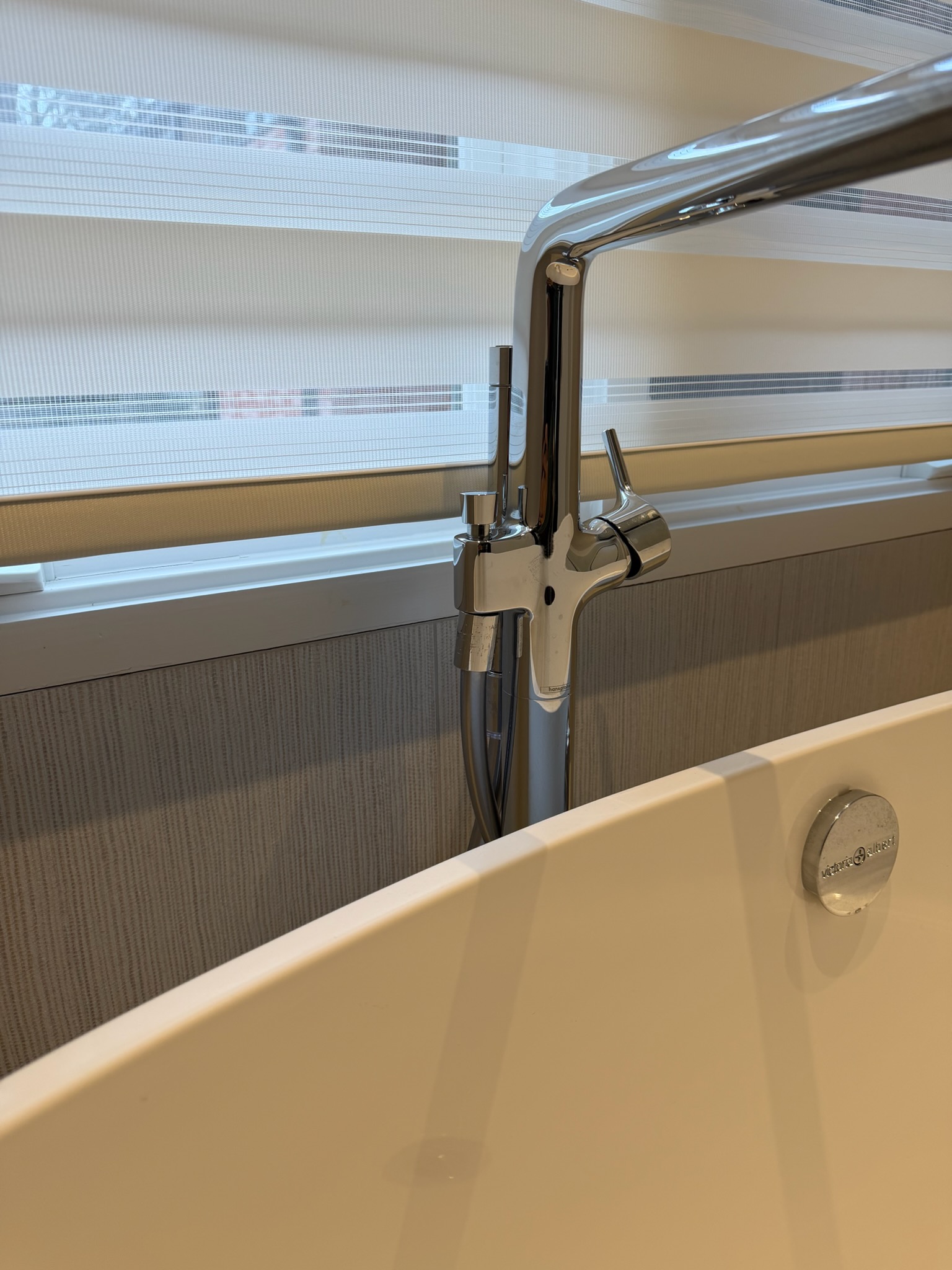 Return to install customer requested hammer arrestor replacements on washing machine. 

Replaced hammer arrestors with dedicated pair. Cut drywall below washing machine box and installed new shut offs with hammer arrestors. 
During this visit I also rechecked water pressure. During this check I noticed significant fluctuation on the gauge when checking pressure. Further targeted inspection revealed that the two water heaters in the basement had only one undersized expansion tank, and that it was isolated from the water heaters by check valves serving the recirculating systems.

I discussed concerns, specifically stating that I believe water hammer is being made worse by this situation. We installed new dedicated thermal expansion tanks and corrected the isolation by repiping both cold water inlets. Both expansion tanks have been set to 60psi to match the operating pressure that was read at the home. 

We also installed a halo whole house carbon filter with bypass. I returned the follow