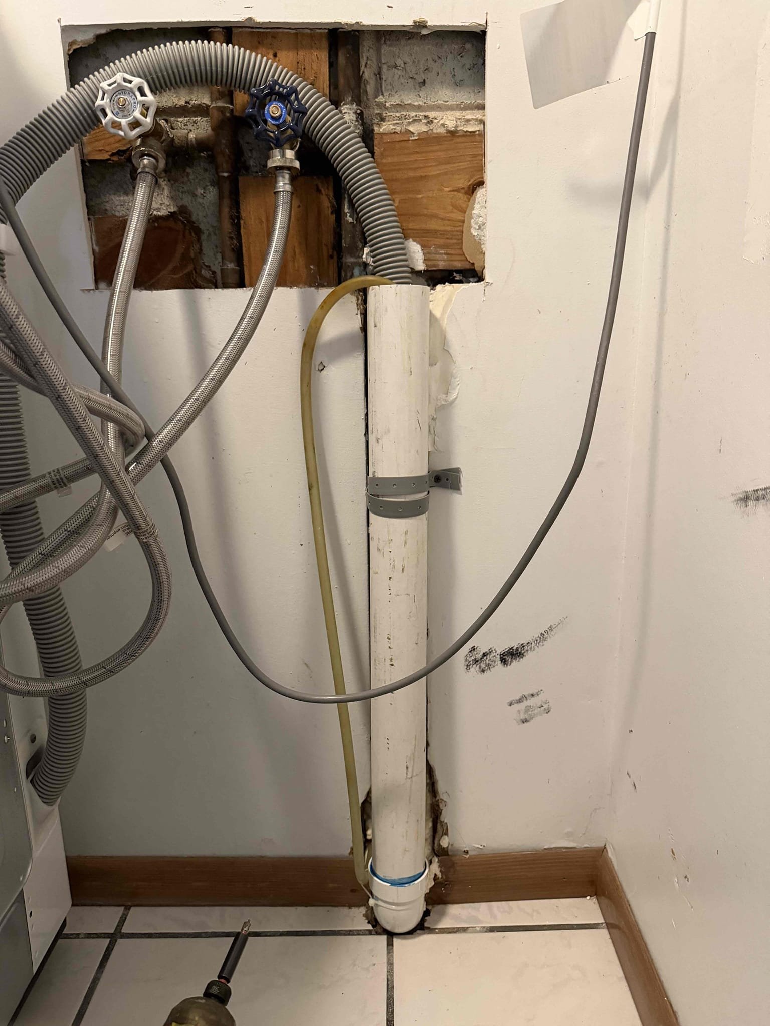 Cut Sheetrock to access plumbing. Once plumbing is exposed give quote to install new drain line and wash machine box.
Replace water shut off valves for laundry box and also install new pvc piping for laundry drain.

Installed quoted work. Tested all work and no leaks were present at this time. Also ran snake through laundry drain. Tested draining now. Laundry is draining as it should.  Cleaned up work area.