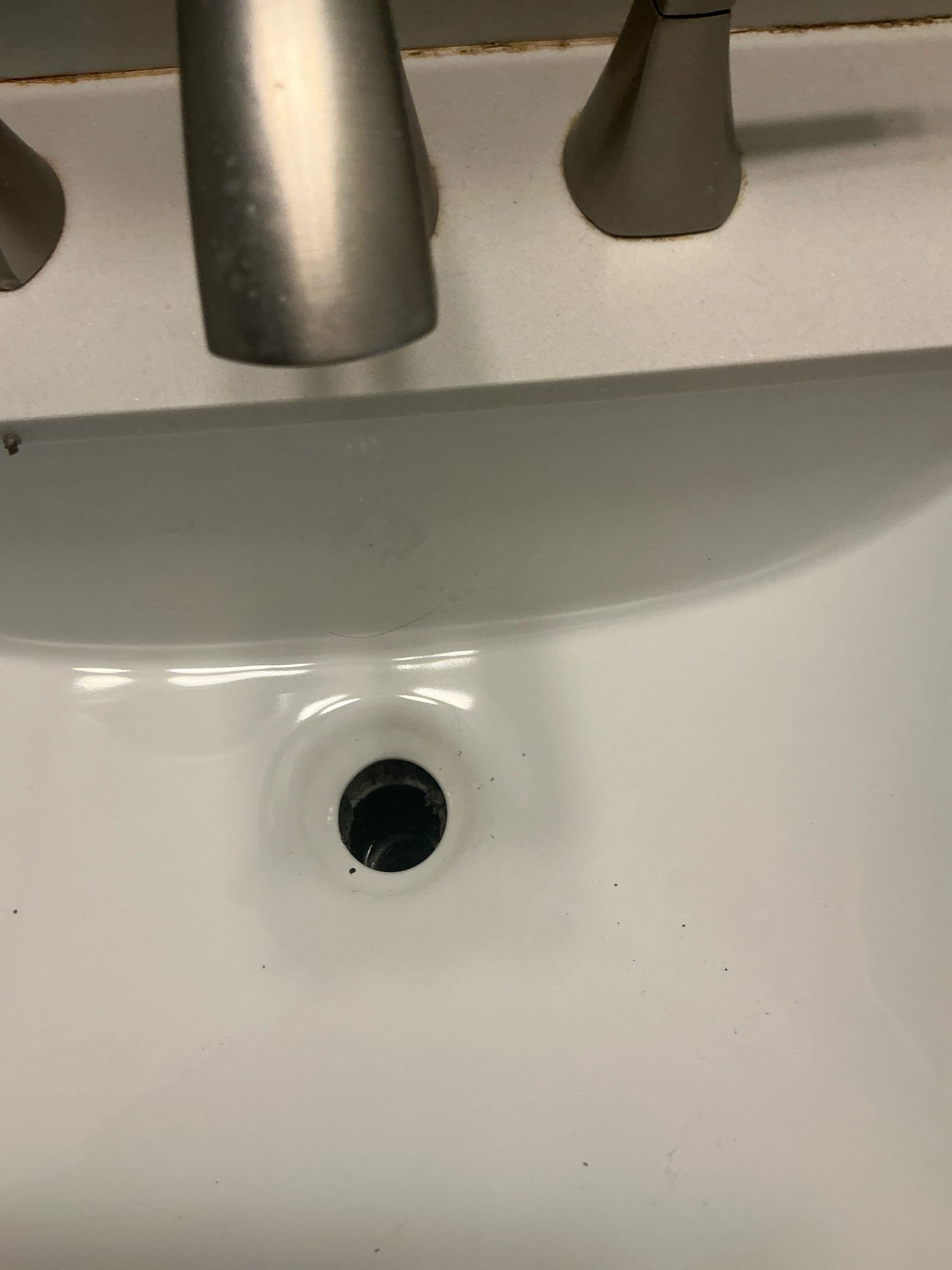 Found lavatory pop up assembly leaking in hall restroom. Removed pop up assembly and inspected for damage. Found putty was missing in a section. Puttied pop up assembly and reinstalled. Filled lavatory and drained to test pop up assembly. Advised customer that it is not recommended to flush water heater due to age. Checked toilet for leaks. No leaks at this time. Dan gave authorization over phone.