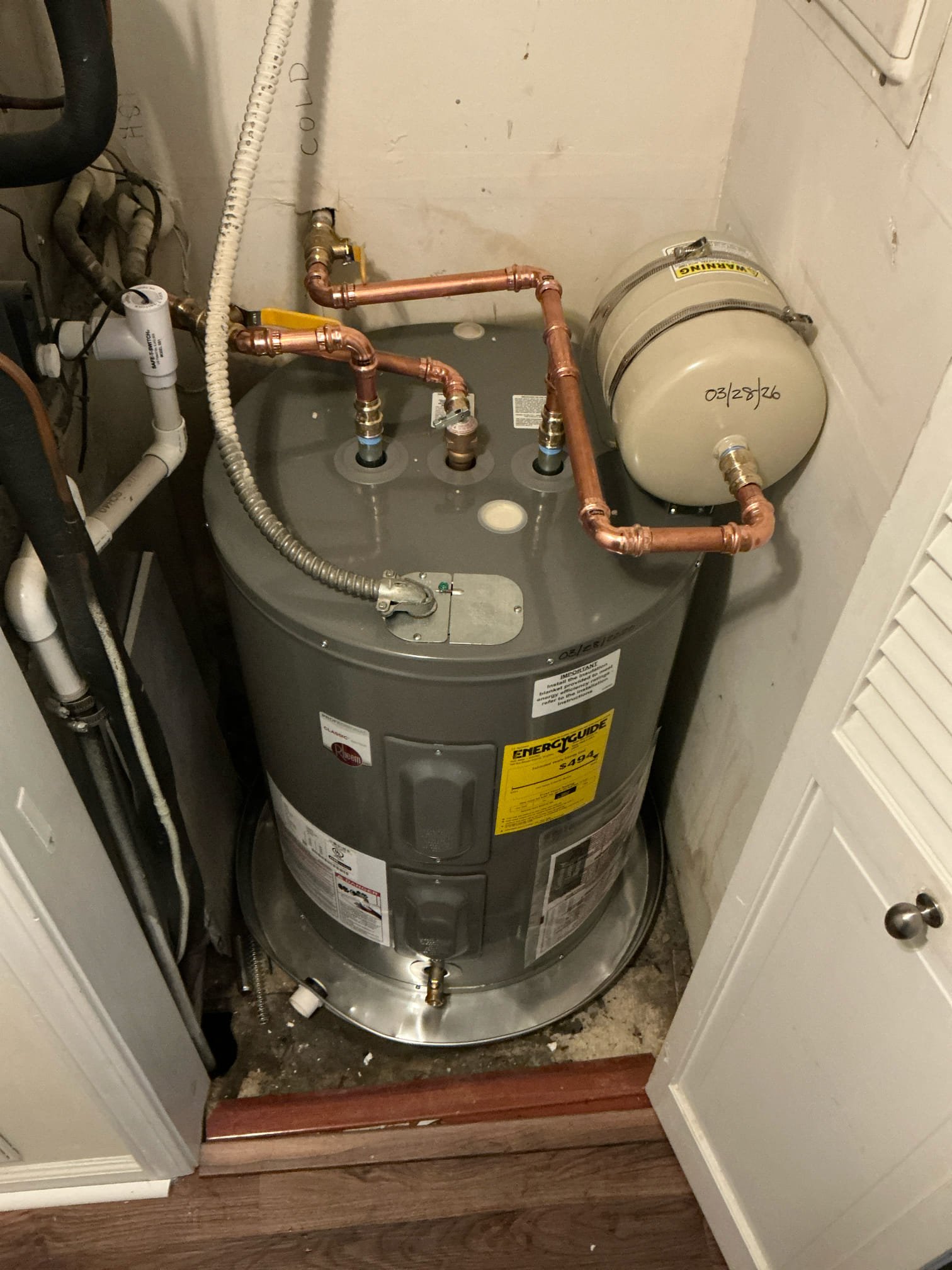 Shut off water to building and drain system and old water heater. Cut out and remove old water heater and leaking hoses on top. Install new lowboy electric water heater and Install new shut off valve for water heater and new thermal expansion tank. Test for proper operation and leaks 