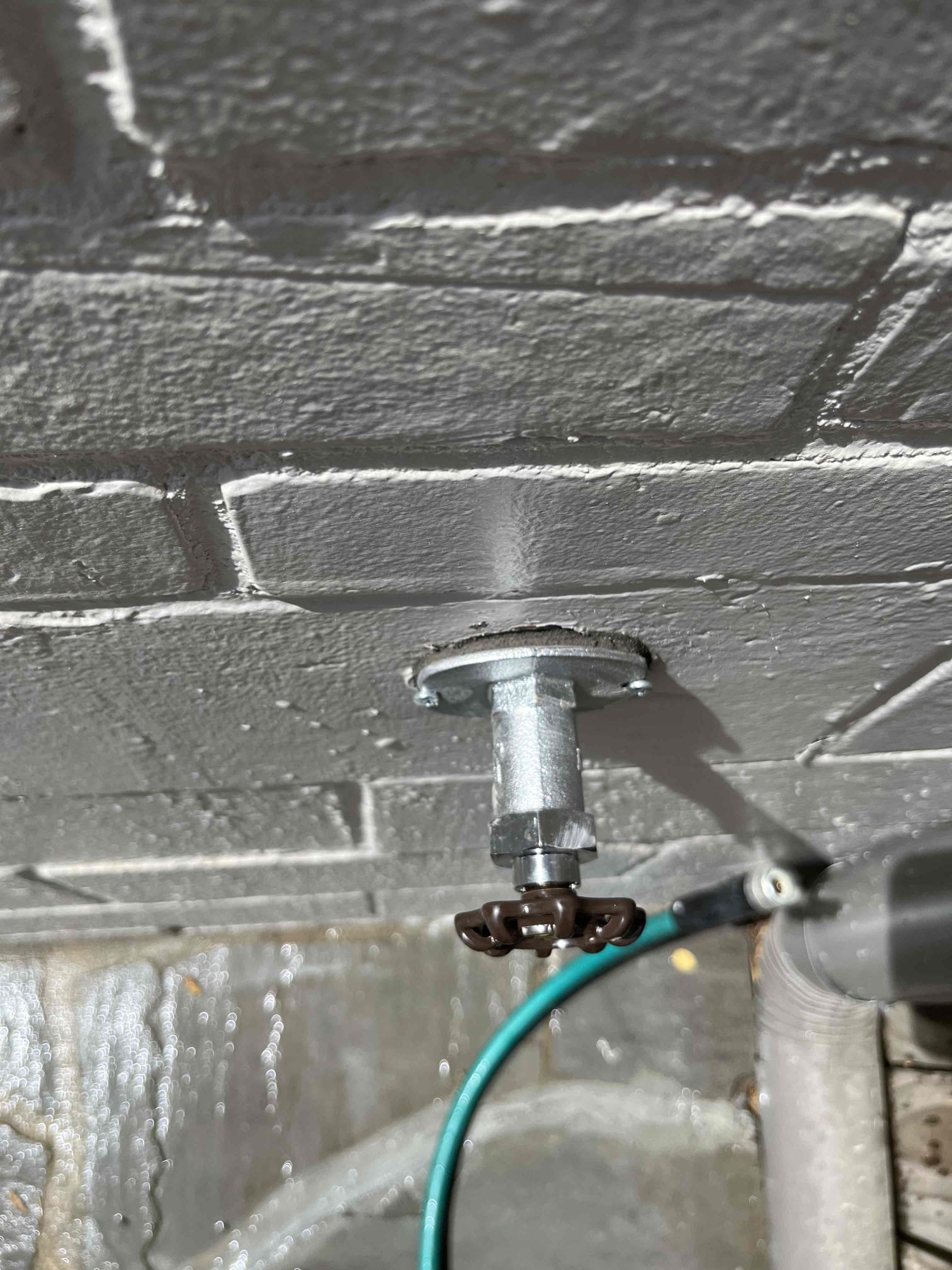 Replaced leaking frost proof hose bib by driveway. Resealed with hydraulic cement and secured with two points of contact. Tested work to ensure proper function and no leaks. Nine were found.