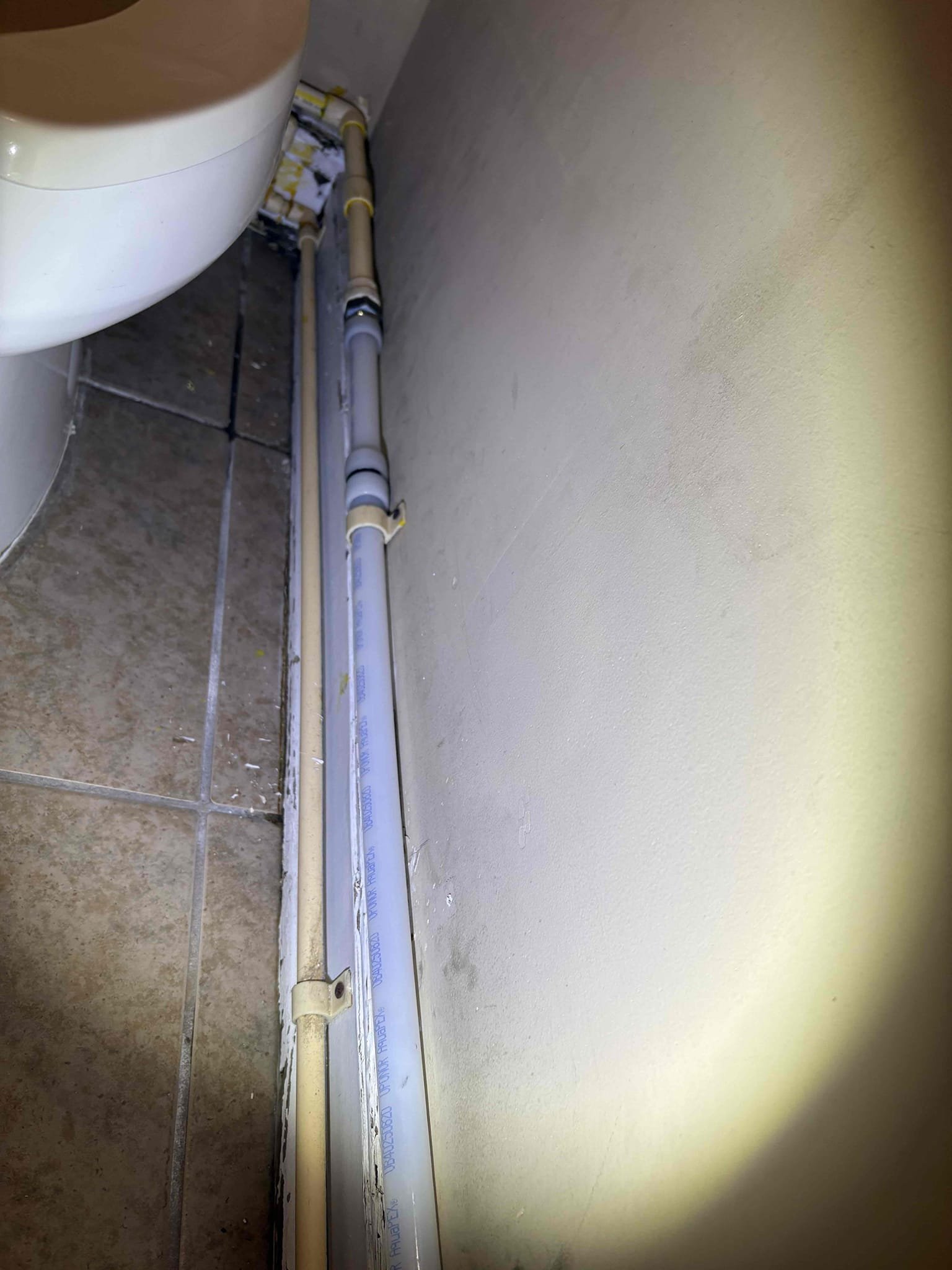 Client called us out due to a leak on a cpvc water line that is running along the base of the wall in the women’s bathroom and around to the other fixtures in the building. It was cracked on a 45 offset and slowly dripping down. We turned water off and cut out that leaking section and some more pipe and adapted to Pex a. Put line back in Pex a water pipe and restrapped to the wall as it was. Turned water back on and tested, no leaks. 

Unable to check water pressure. 