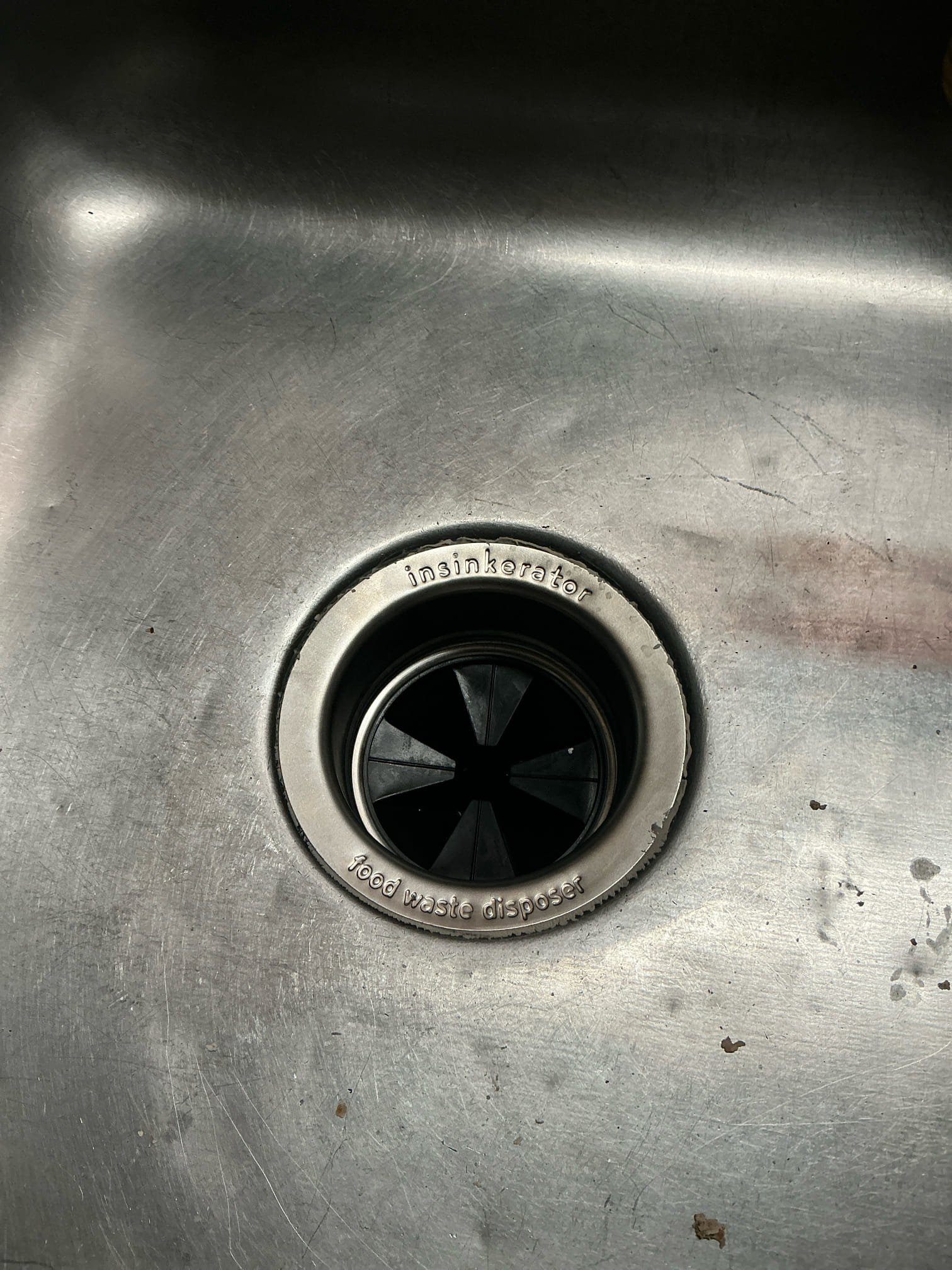 Remove old leaking garbage disposal and collar. Install new garbage disposal and test for proper operation and leaks 