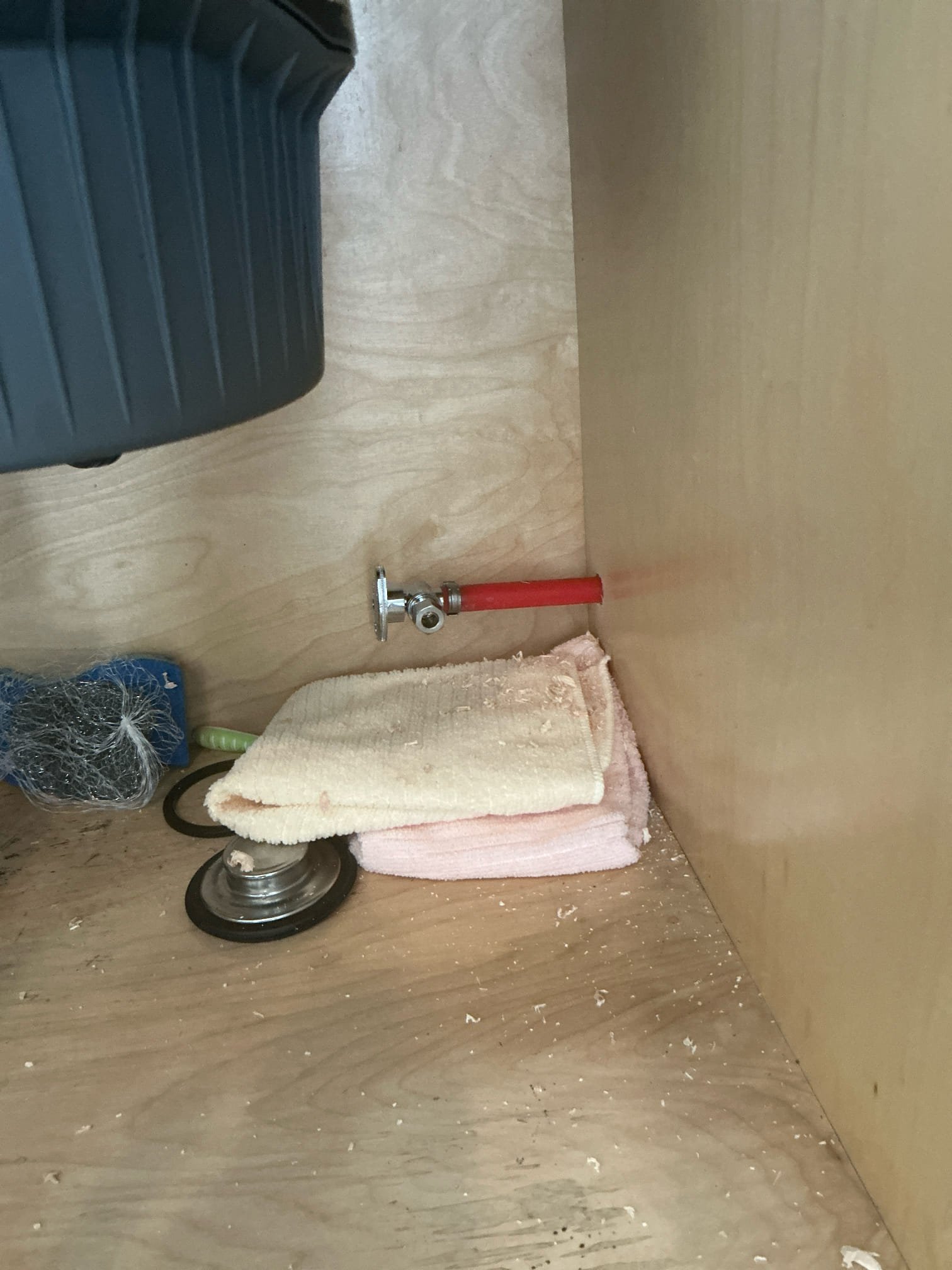 Found stop valve for dishwasher behind dishwasher. Moved stop valve under kitchen cabinet by customer request. Drilled additional hole in cabinet for supply line.